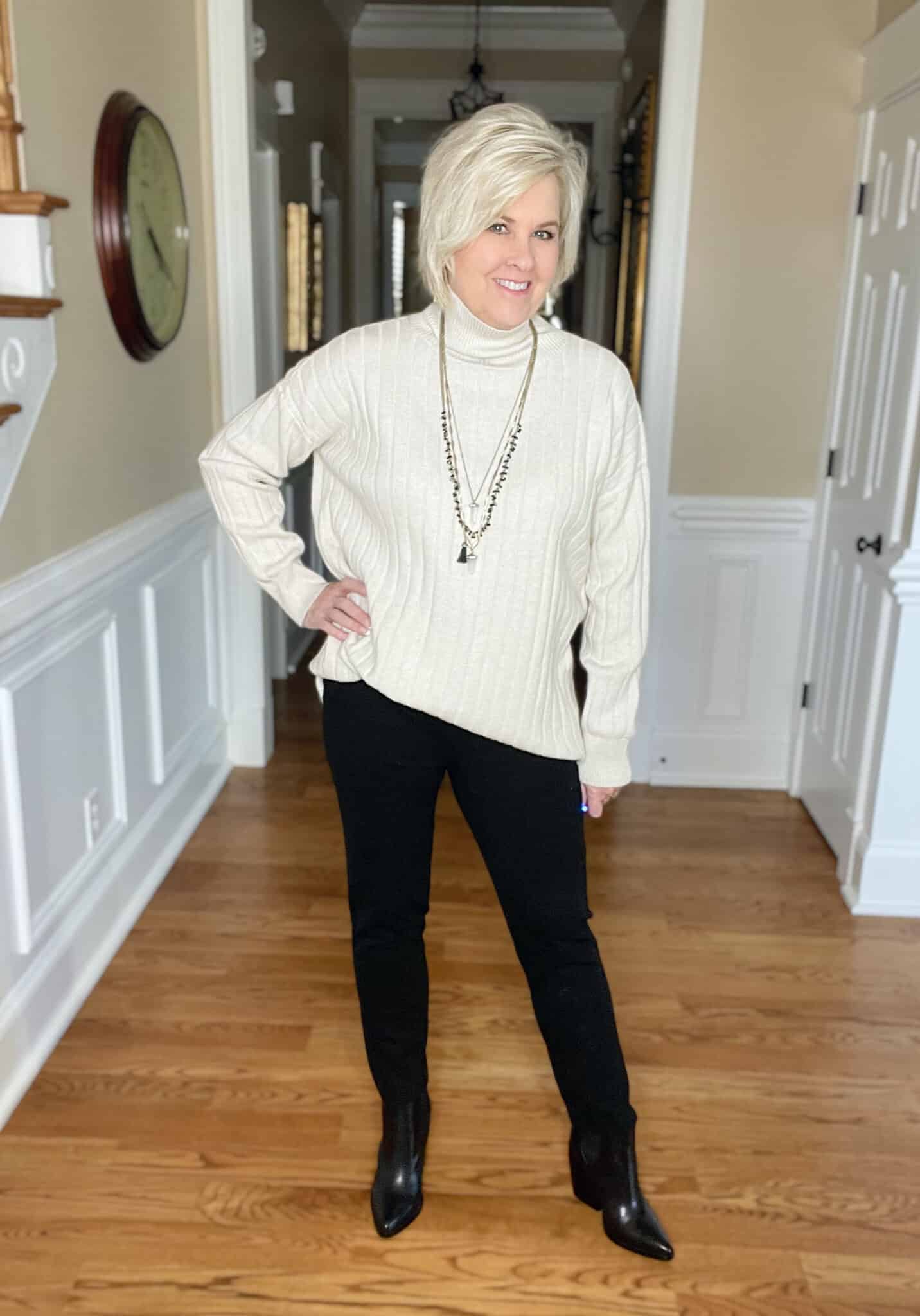 Over 40 Fashion Blogger, Tania Stephens is wearing an oversized ivory sweater with skinny pants in black