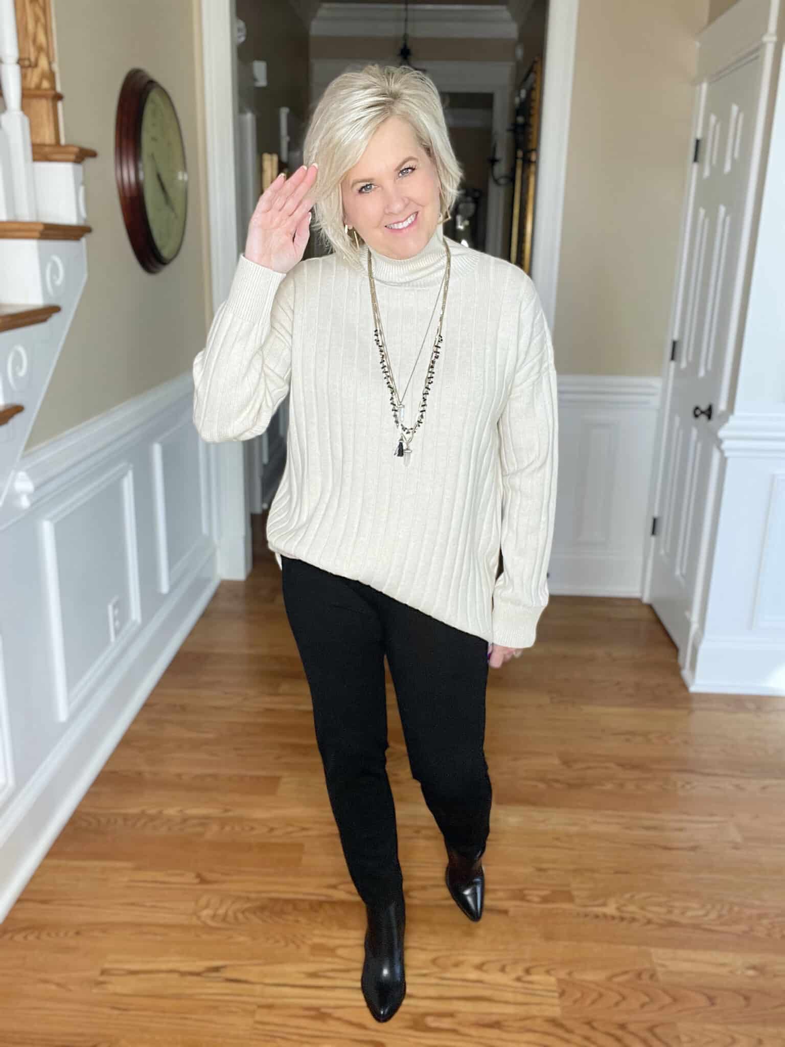 Over 40 Fashion Blogger, Tania Stephens is wearing an oversized ivory sweater with Spanx black perfect pants