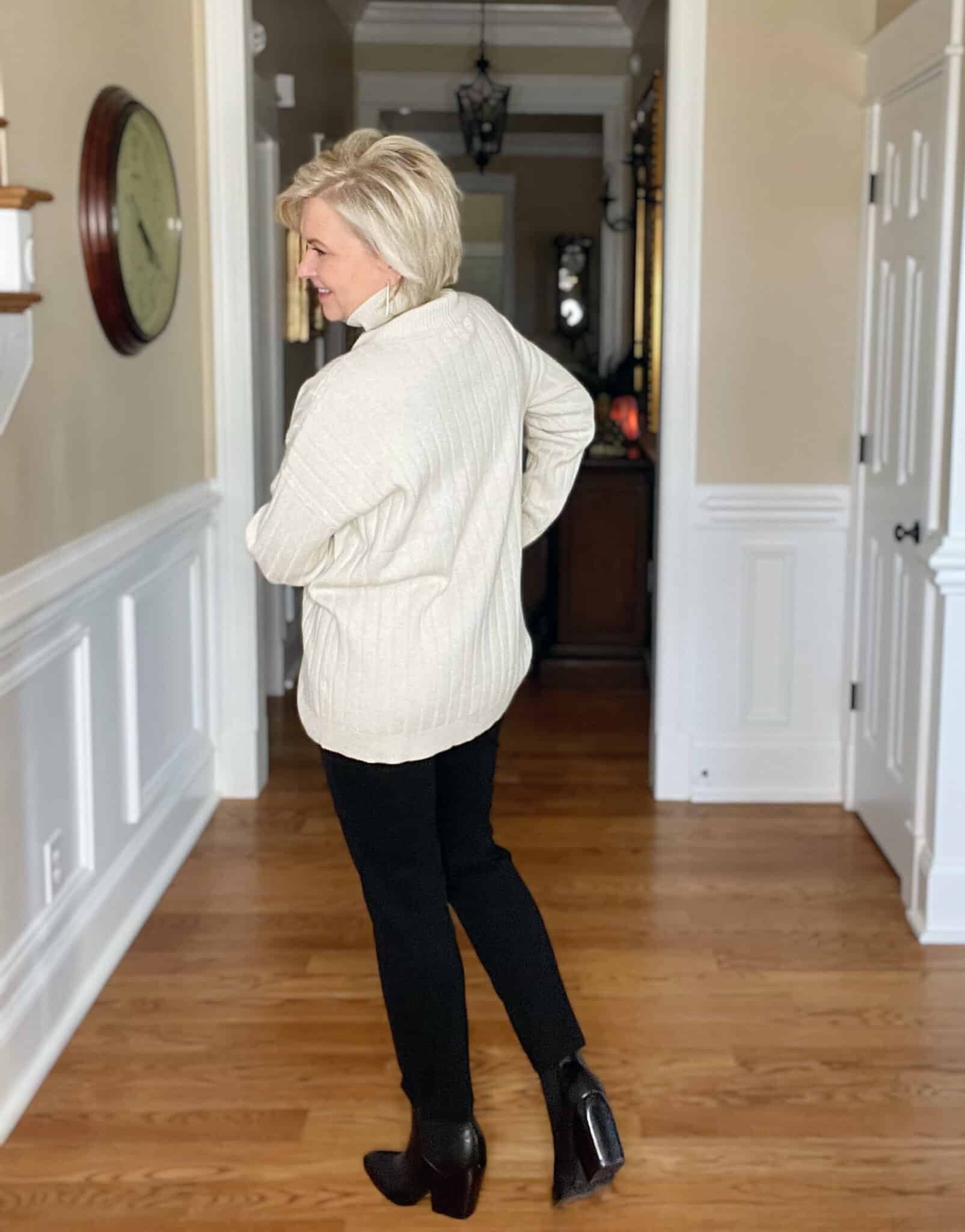 Over 40 Fashion Blogger, Tania Stephens is showing the back of an oversized ivory sweater with Spanx black perfect pants
