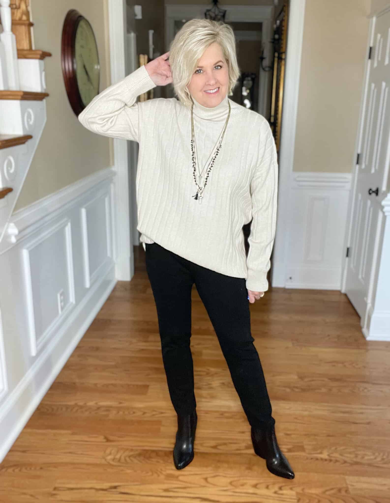 Over 40 Fashion Blogger, Tania Stephens is wearing an oversized ivory sweater with Spanx perfect pants in black