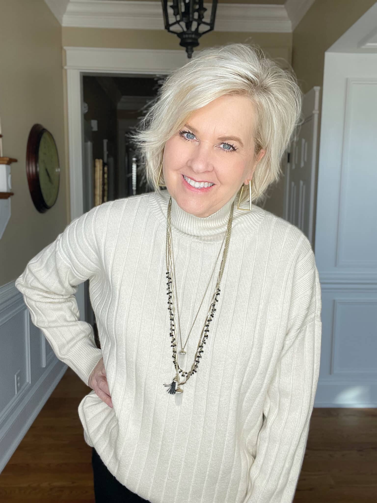 Over 40 Fashion Blogger, Tania Stephens is wearing an oversized ivory sweater with a necklace from Isabell