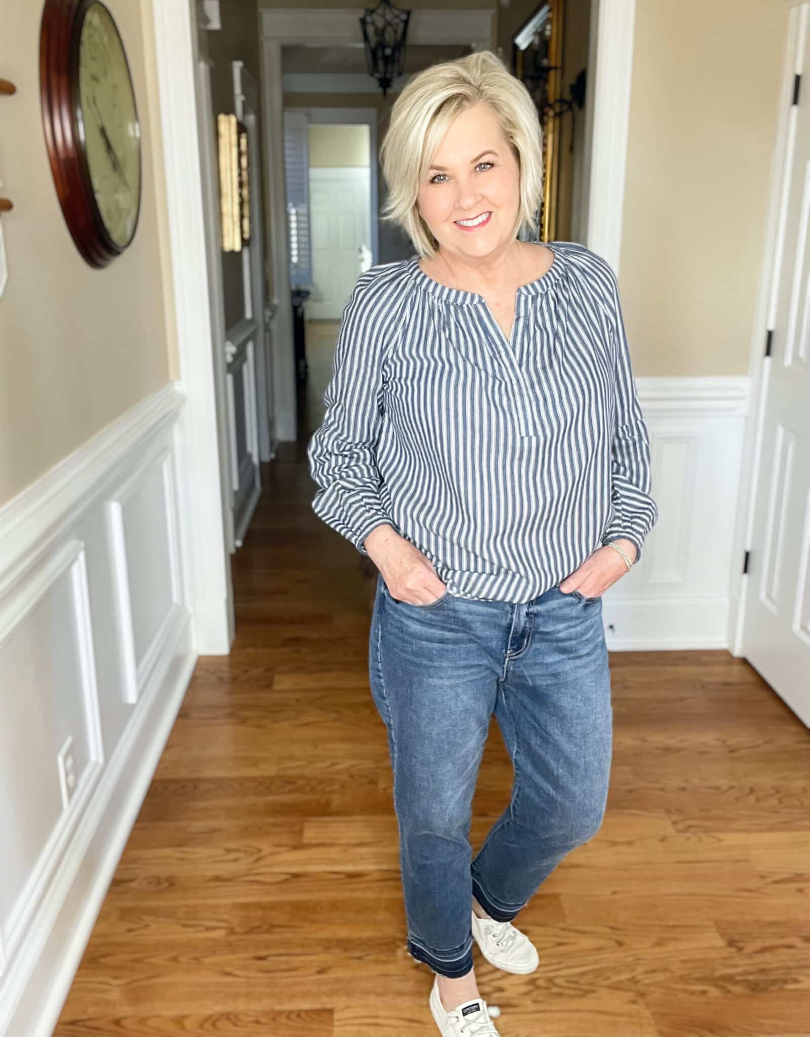 Over 40 Fashion Blogger, Tania Stephens is styling a pair of released hem jeans with Sperry sneakers and a striped shirt