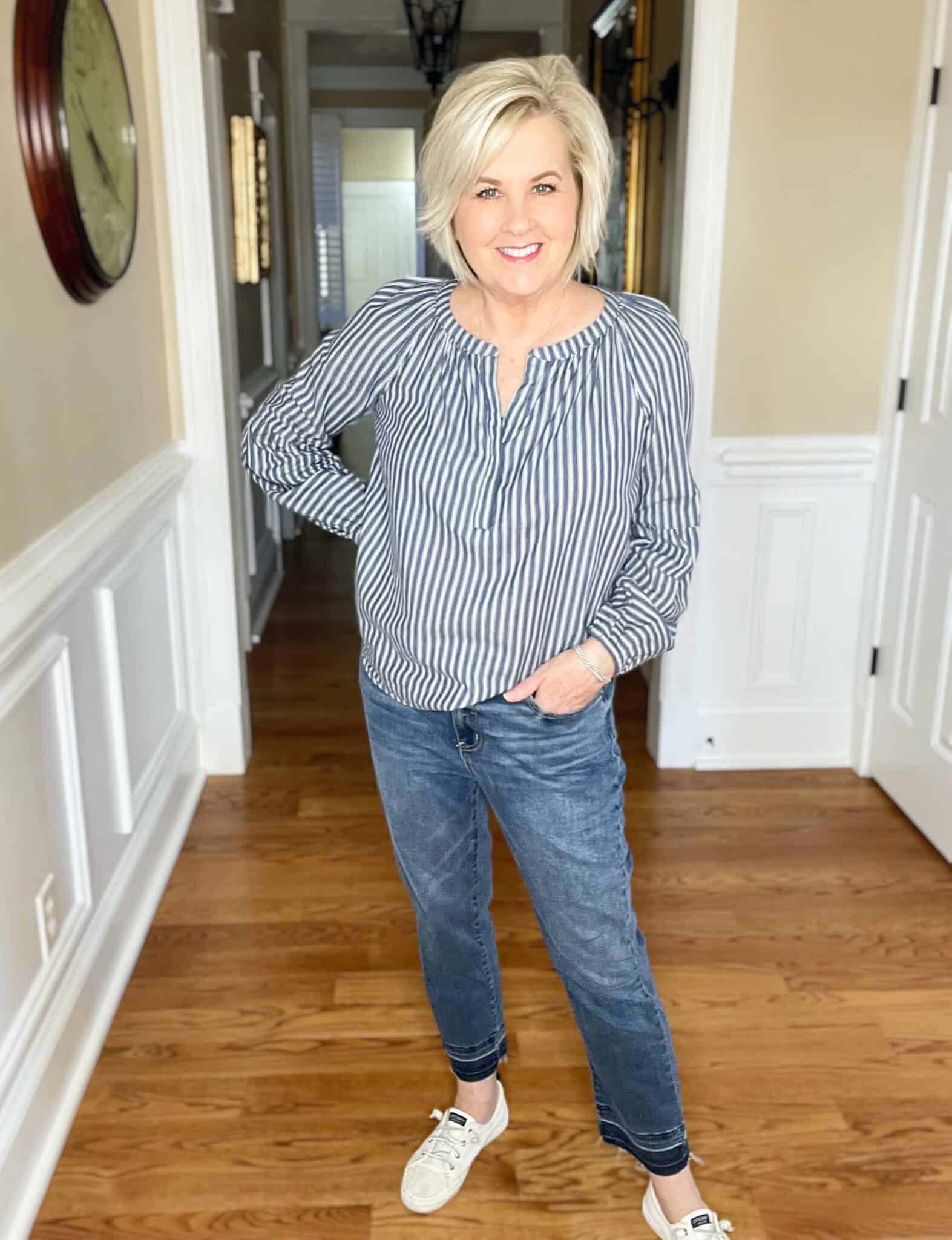 Over 40 Fashion Blogger, Tania Stephens is styling a pair of released hem jeans with sneakers and a striped shirt