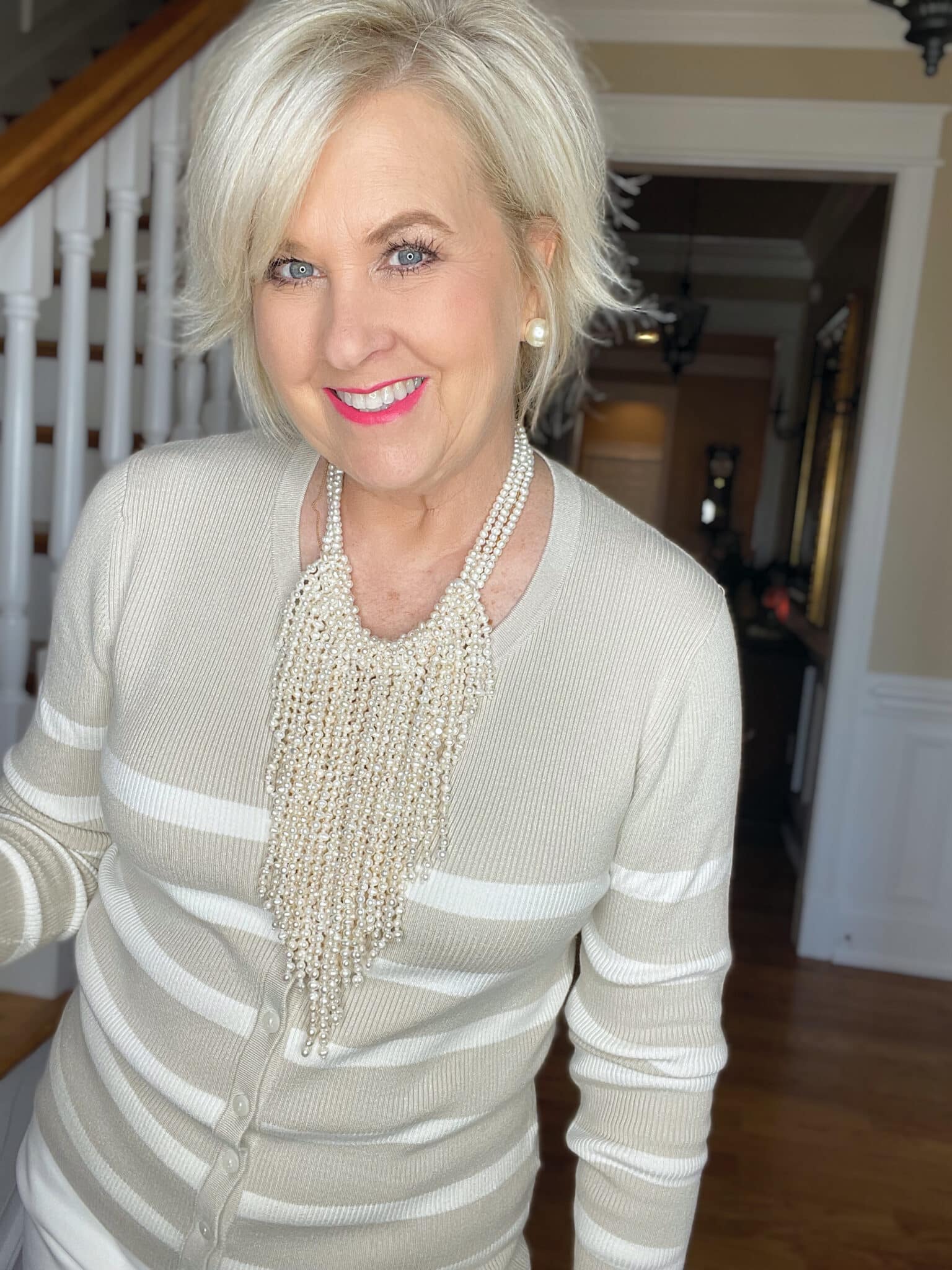 Over 40 Fashion Blogger, Tania Stephens is wearing a beige and white sweater from Walmart a pearl necklace