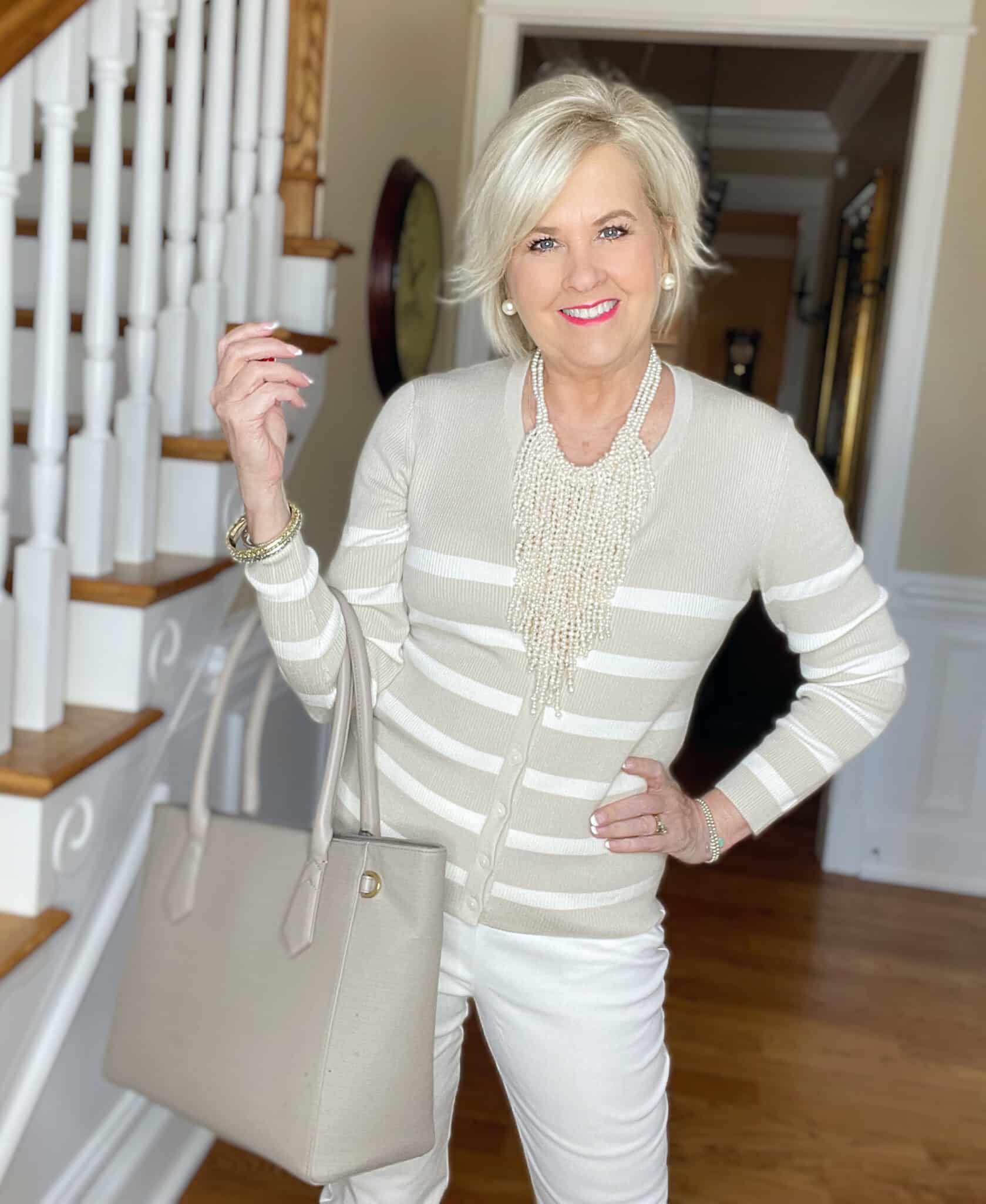 Over 40 Fashion Blogger, Tania Stephens is wearing a beige and white sweater from Walmart and Ecru pants from Chicos