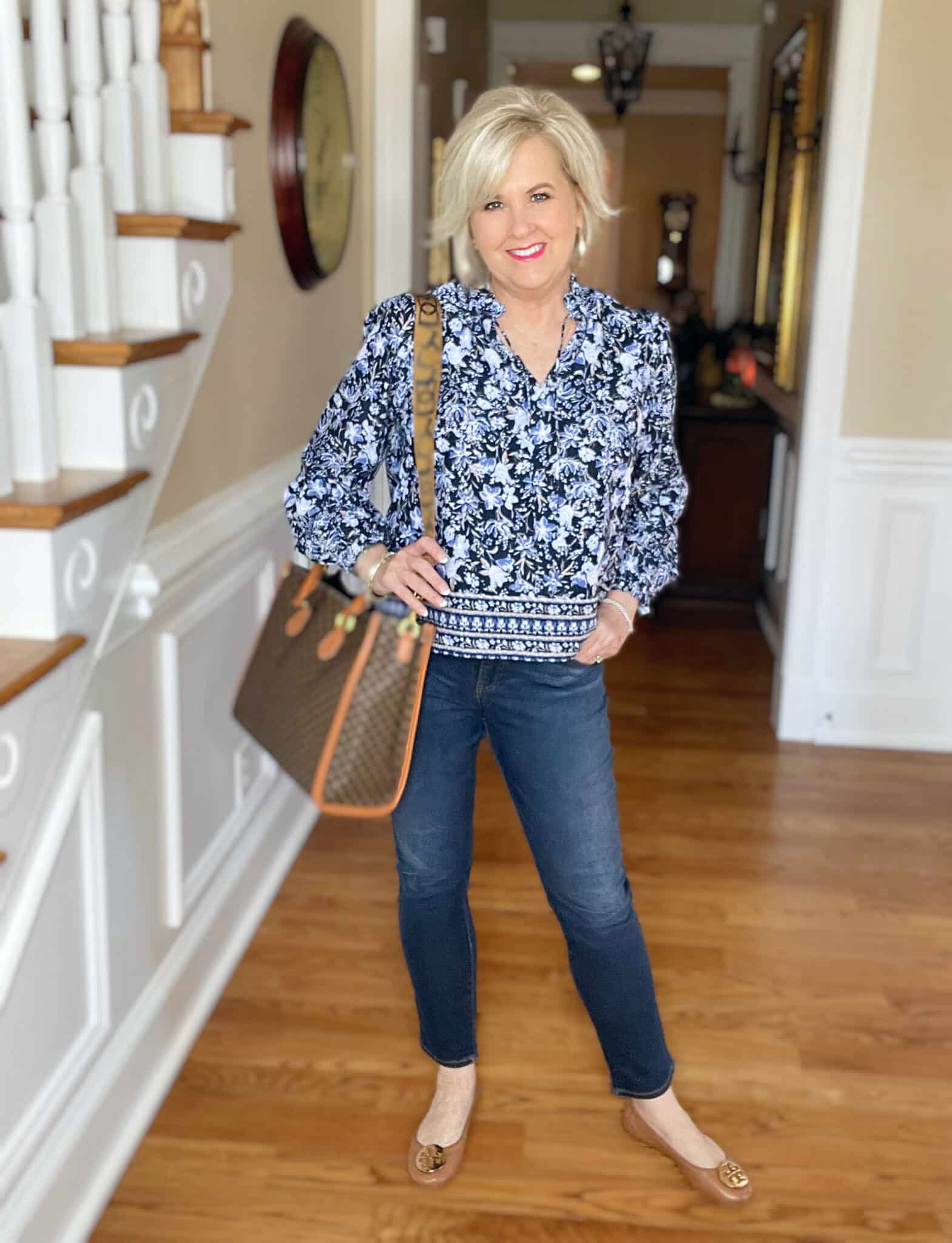 Over 40 Fashion Blogger, Tania Stephens is wearing a blue floral top from Walmart and jeggings from Chicos