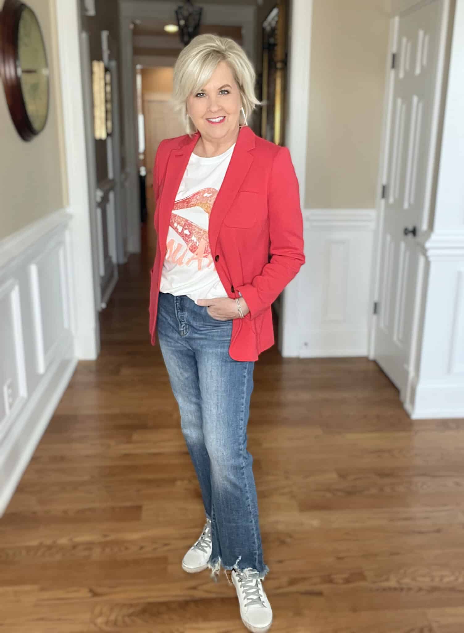 Over 40 Fashion Blogger, Tania Stephens is wearing a red blazer with a lips graphic tee and jeans