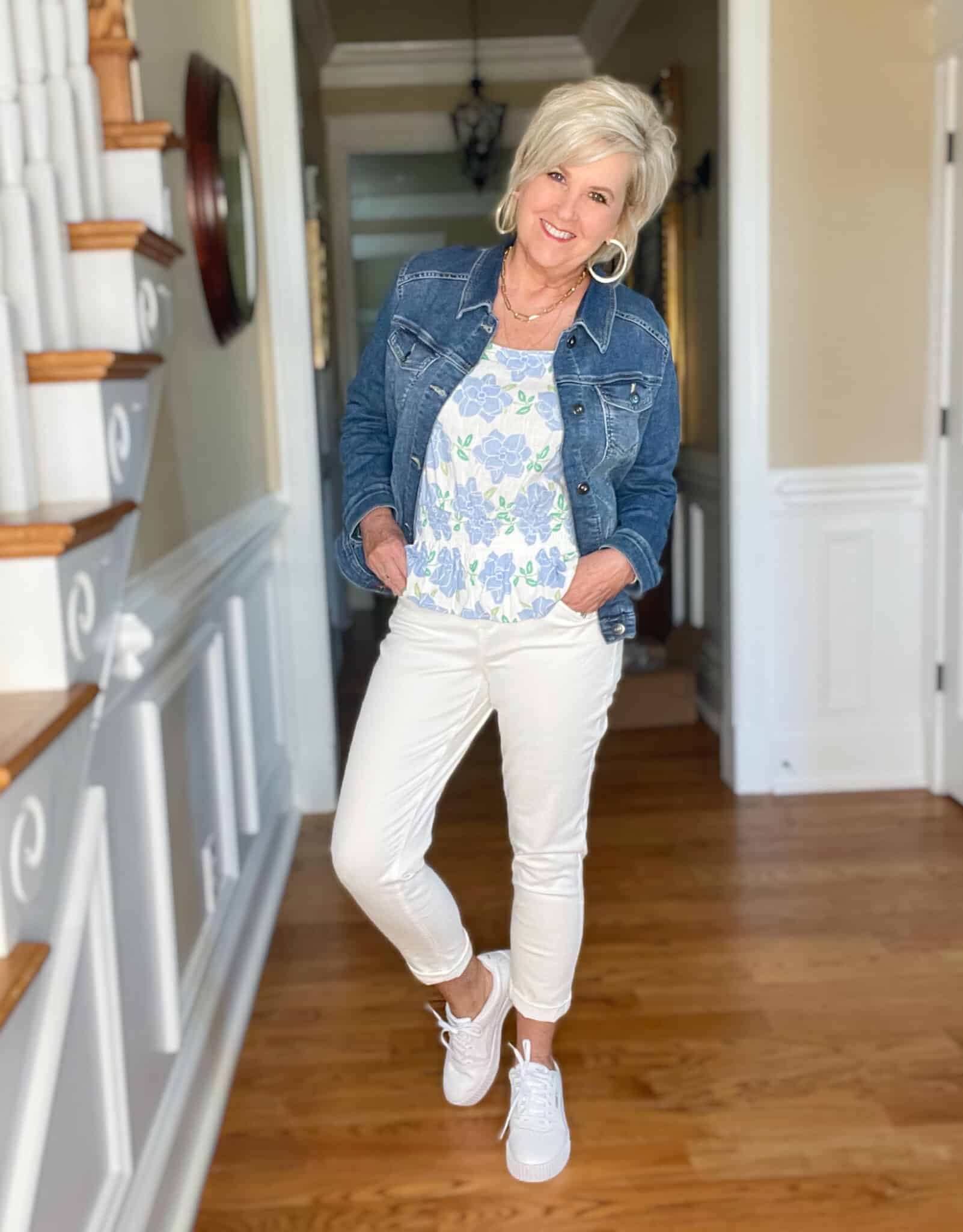 Over 40 Fashion Blogger, Tania Stephens is wearing a Kohl's top, a denim jacket, white jeans, and white sneakers