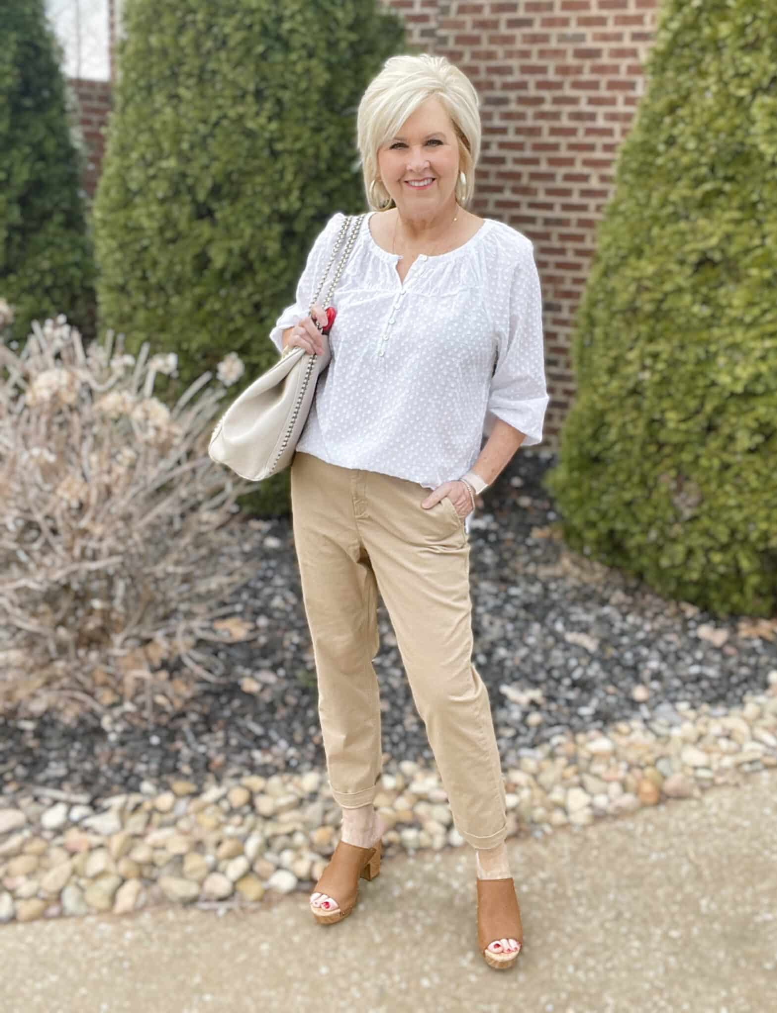 Over 40 Fashion Blogger, Tania Stephens is styling a white henley blouse with tan chino pants