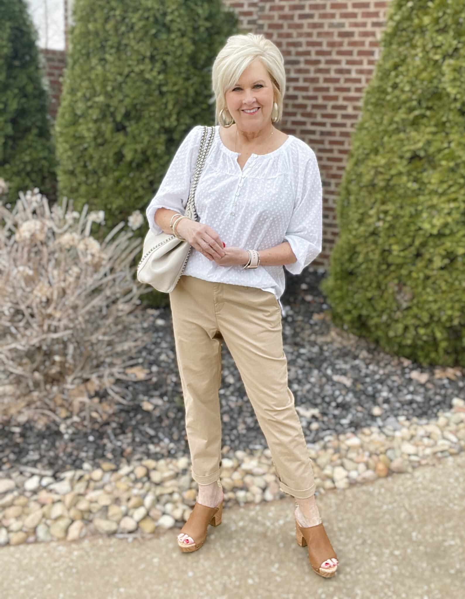 Over 40 Fashion Blogger, Tania Stephens is styling a white henley blouse with chino pants