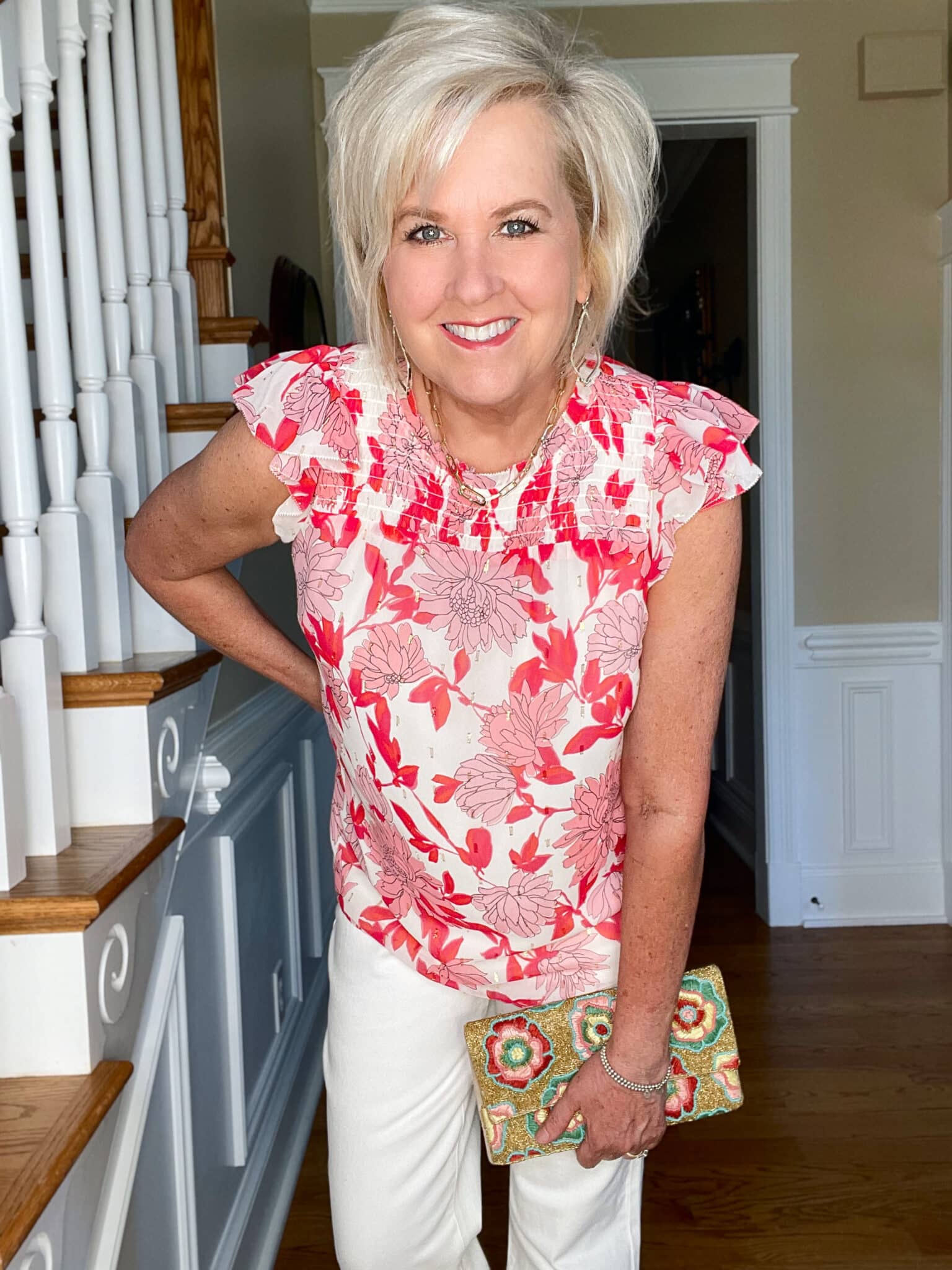 Over 40 Fashion Blogger, Tania Stephens is wearing a pink and white floral top with white jeans and neutral heels12
