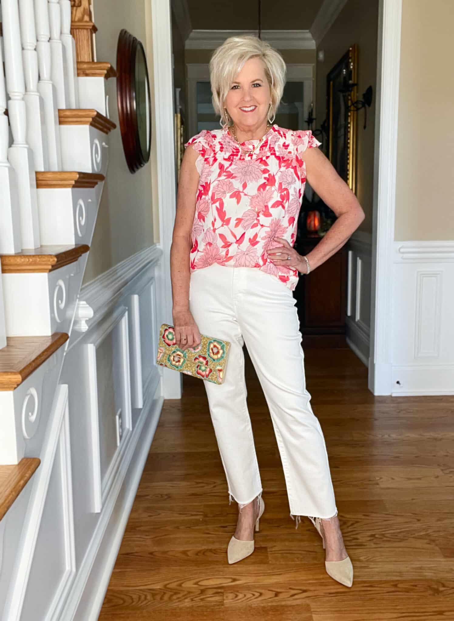 Over 40 Fashion Blogger, Tania Stephens is wearing a pink and white floral top with white jeans and neutral heels3