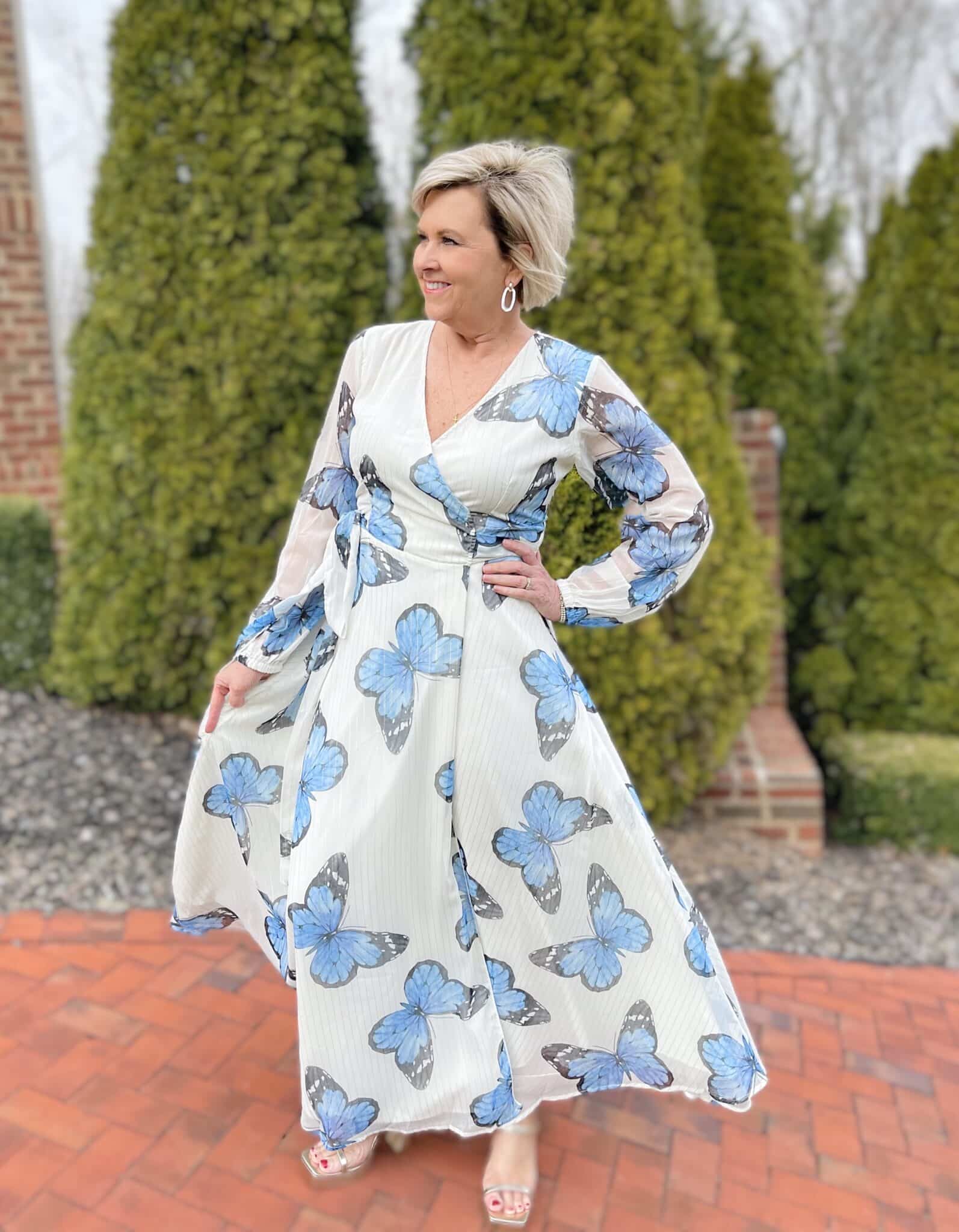 Over 40 Fashion Blogger, Tania Stephens is wearing a long sleeve maxi dress with blue butterflies