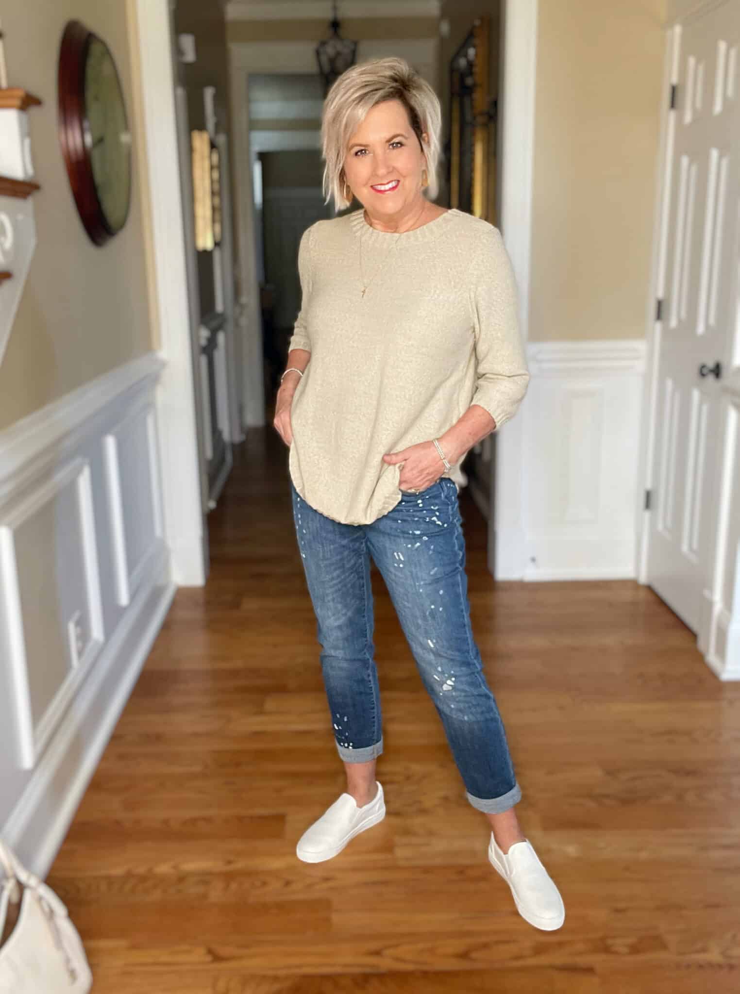 Over 40 Fashion Blogger, Tania Stephens is wearing a beige sweater with paint splattered jeans 10