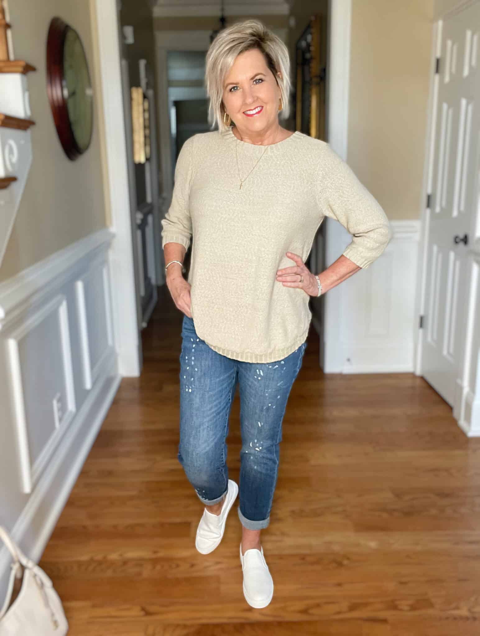 Over 40 Fashion Blogger, Tania Stephens is wearing a beige sweater with paint splattered jeans 15