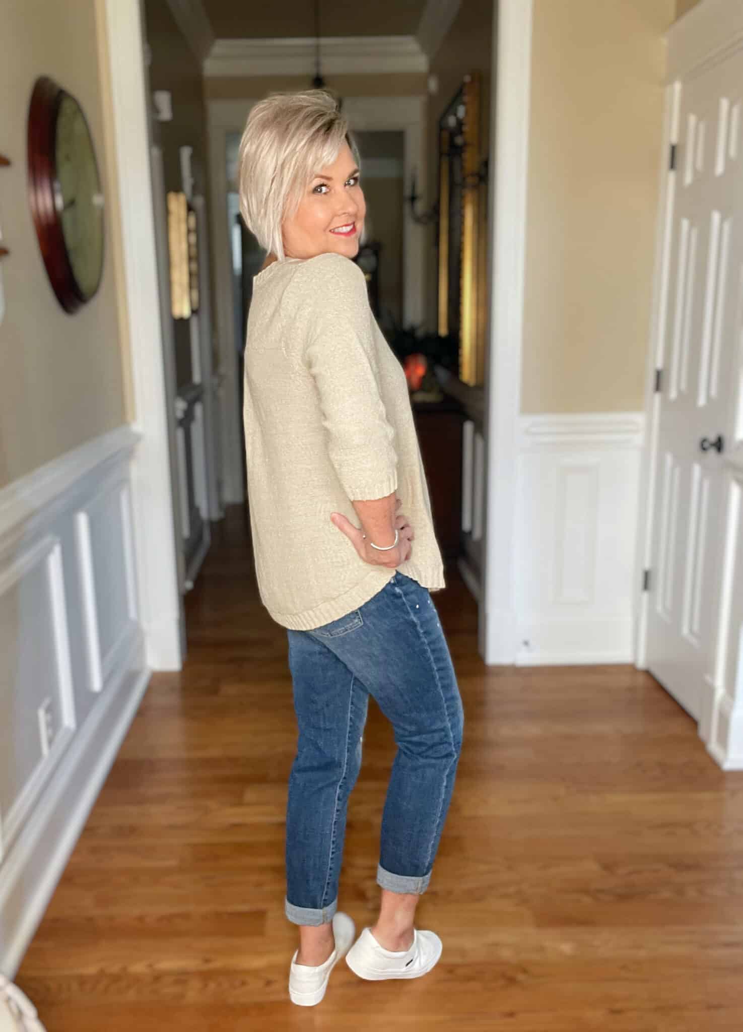 Over 40 Fashion Blogger, Tania Stephens is wearing a beige sweater with paint splattered jeans2