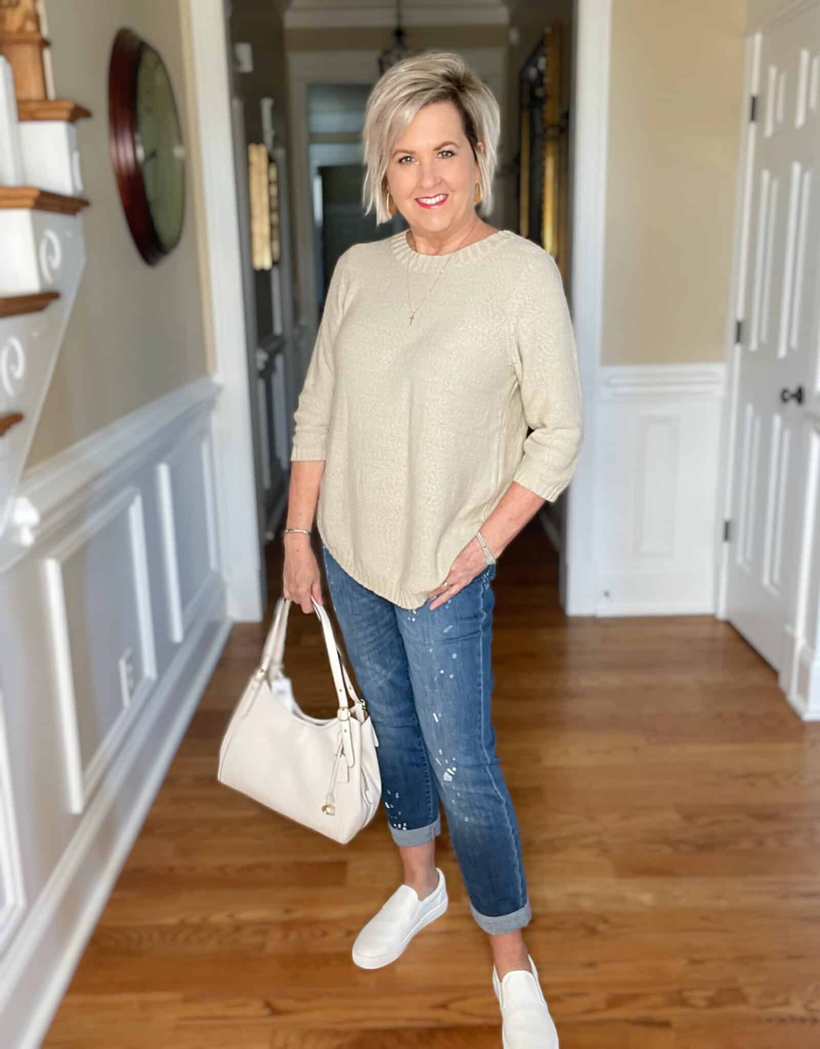 Over 40 Fashion Blogger, Tania Stephens is wearing a beige sweater with paint splattered jeans6