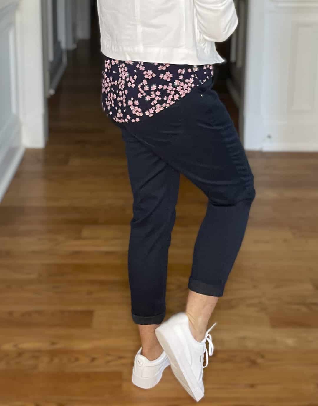 Over 40 Fashion Blogger, Tania Stephens is wearing navy crop pants, a printed top, and a white denim jacket 2