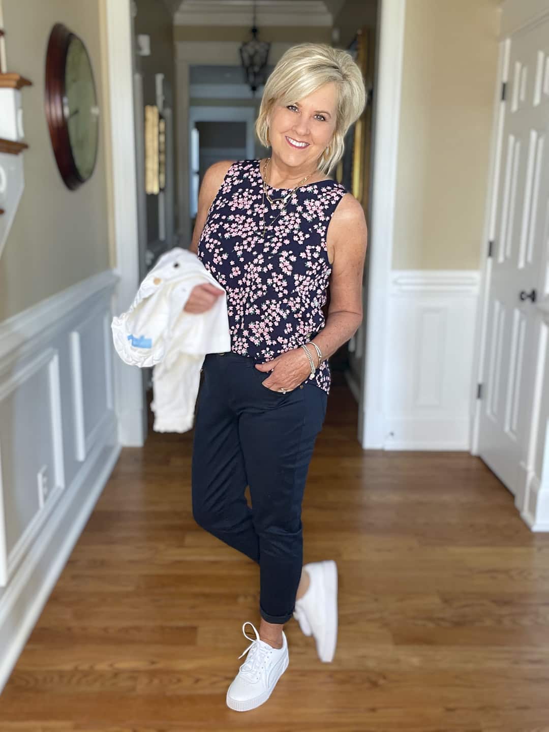 Over 40 Fashion Blogger, Tania Stephens is wearing navy crop pants, a printed top, and a white denim jacket 4