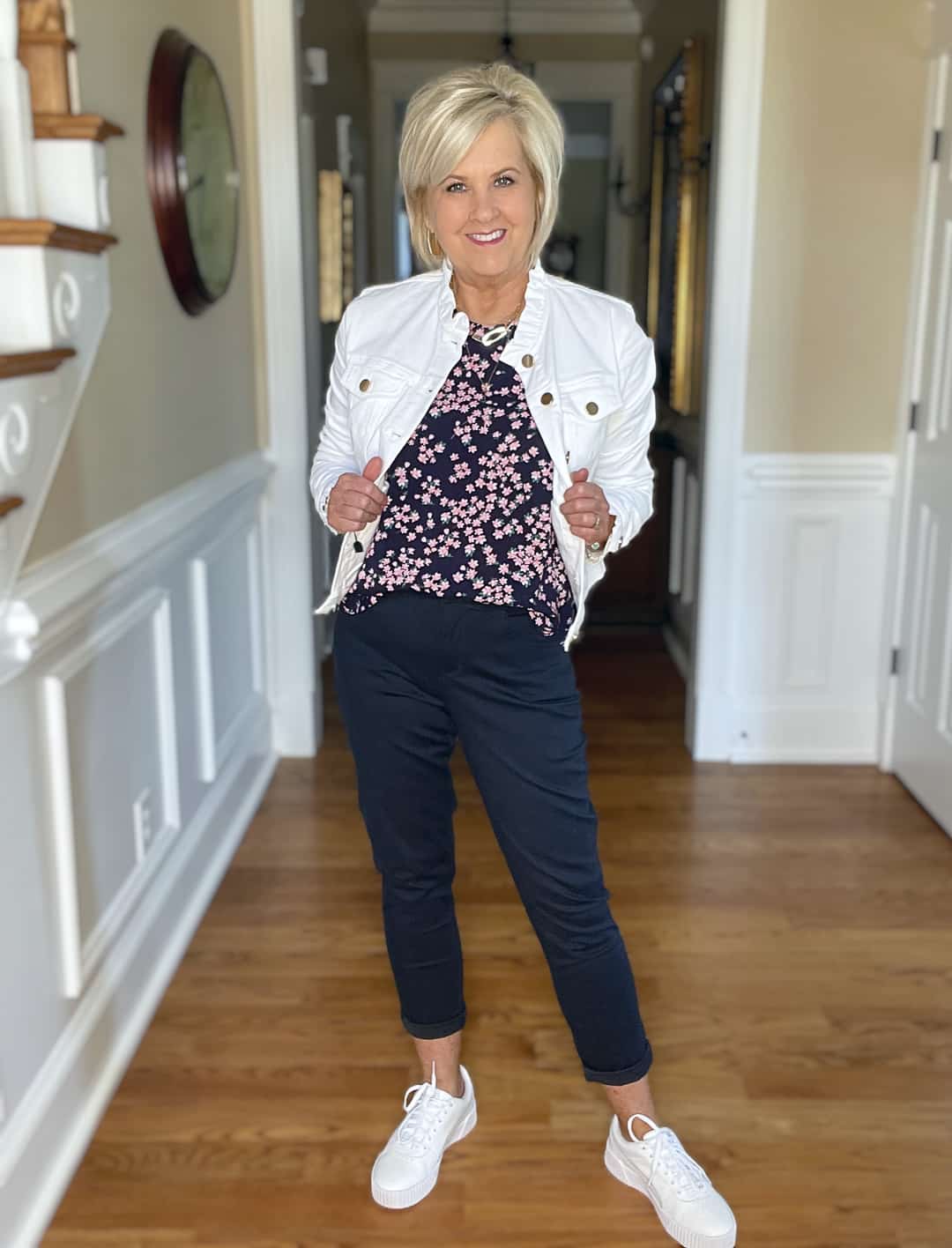 Over 40 Fashion Blogger, Tania Stephens is wearing navy crop pants, a printed top, and a white denim jacket 7