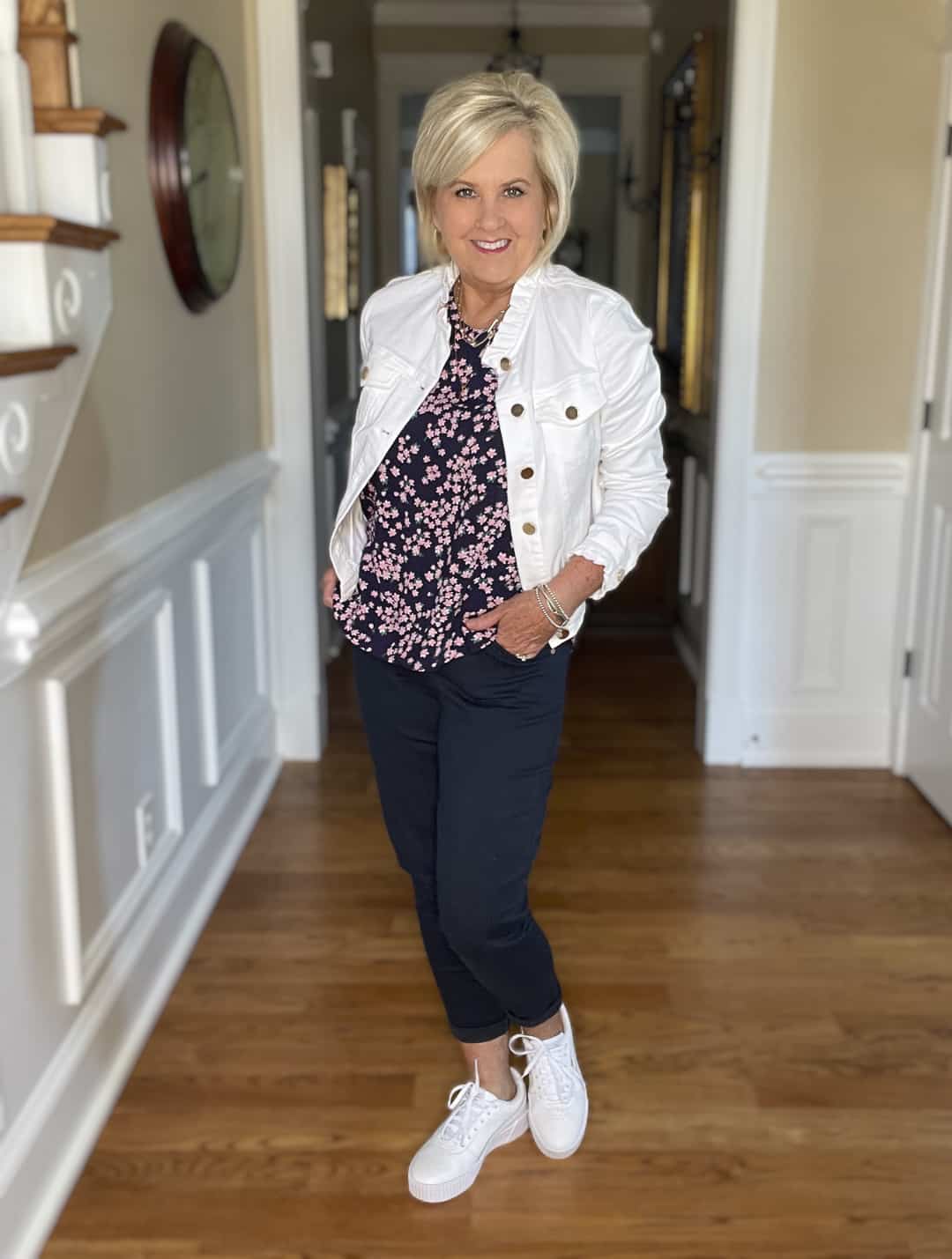 Over 40 Fashion Blogger, Tania Stephens is wearing navy crop pants, a printed top, and a white denim jacket 8