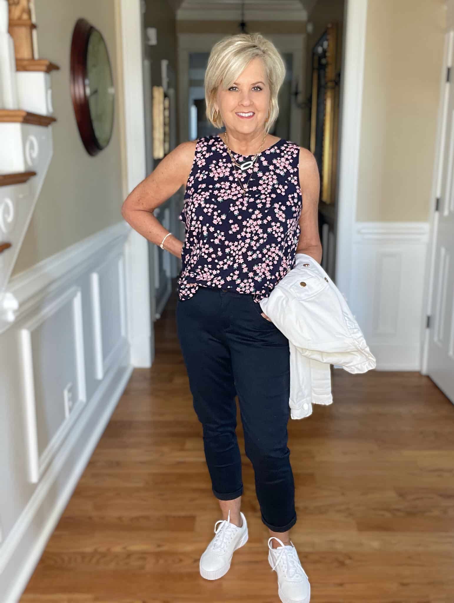 Over 40 Fashion Blogger, Tania Stephens is wearing navy crop pants, a printed top, and a white denim jacket 34