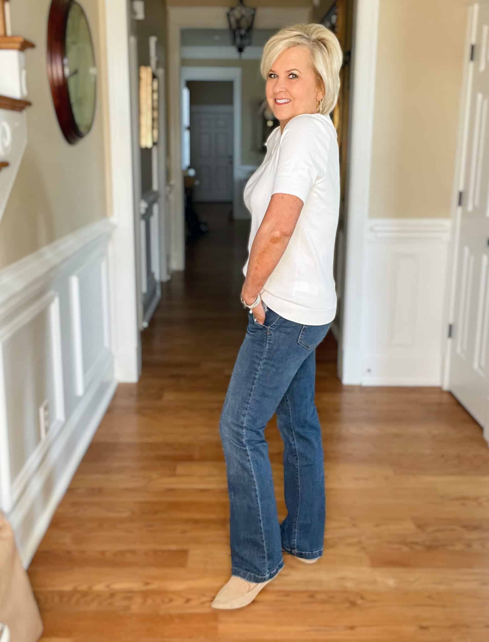 Over 40 Fashion Blogger, Tania Stephens is wearing a white cashmere blend tee, straight cut jeans, a navy double breasted blazer, and carrying a neutral handbag 15