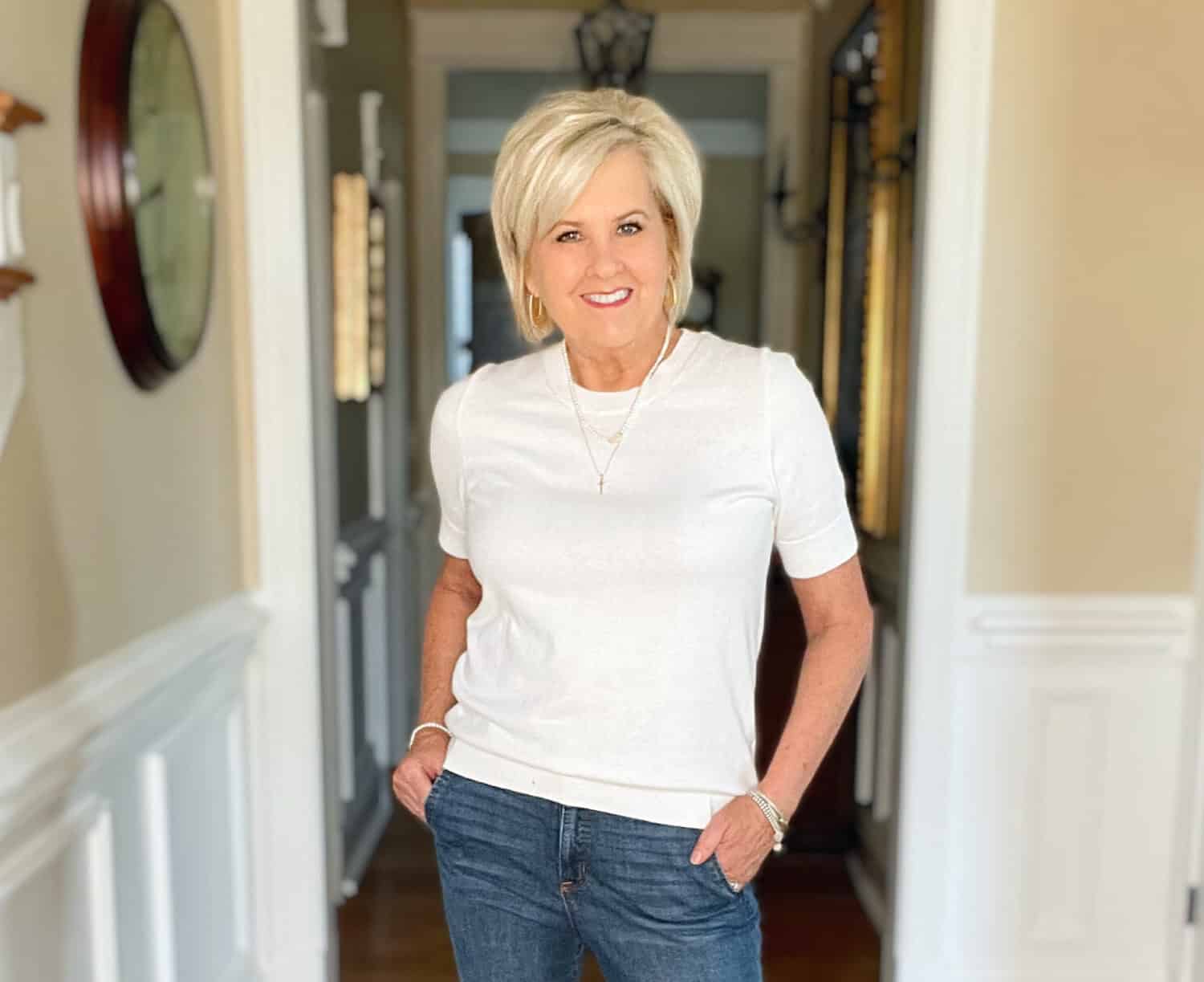 Over 40 Fashion Blogger, Tania Stephens is wearing a white cashmere blend tee, straight cut jeans, a navy double breasted blazer, and carrying a neutral handbag 28