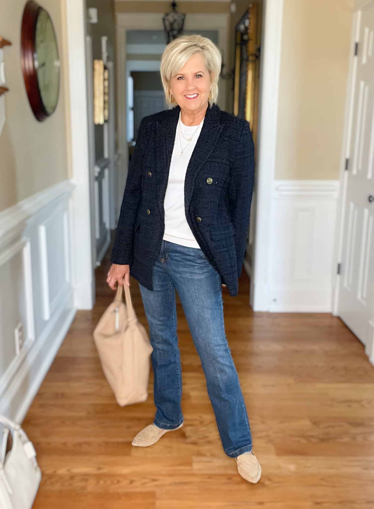 Over 40 Fashion Blogger, Tania Stephens is wearing a white cashmere blend tee, straight cut jeans, a navy double breasted blazer, and carrying a neutral handbag4