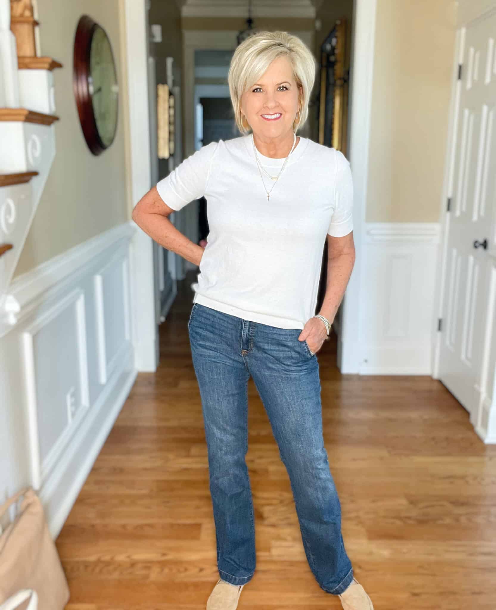 Over 40 Fashion Blogger, Tania Stephens is wearing a white cashmere blend tee, straight cut jeans, a navy double breasted blazer, and carrying a neutral handbag 9