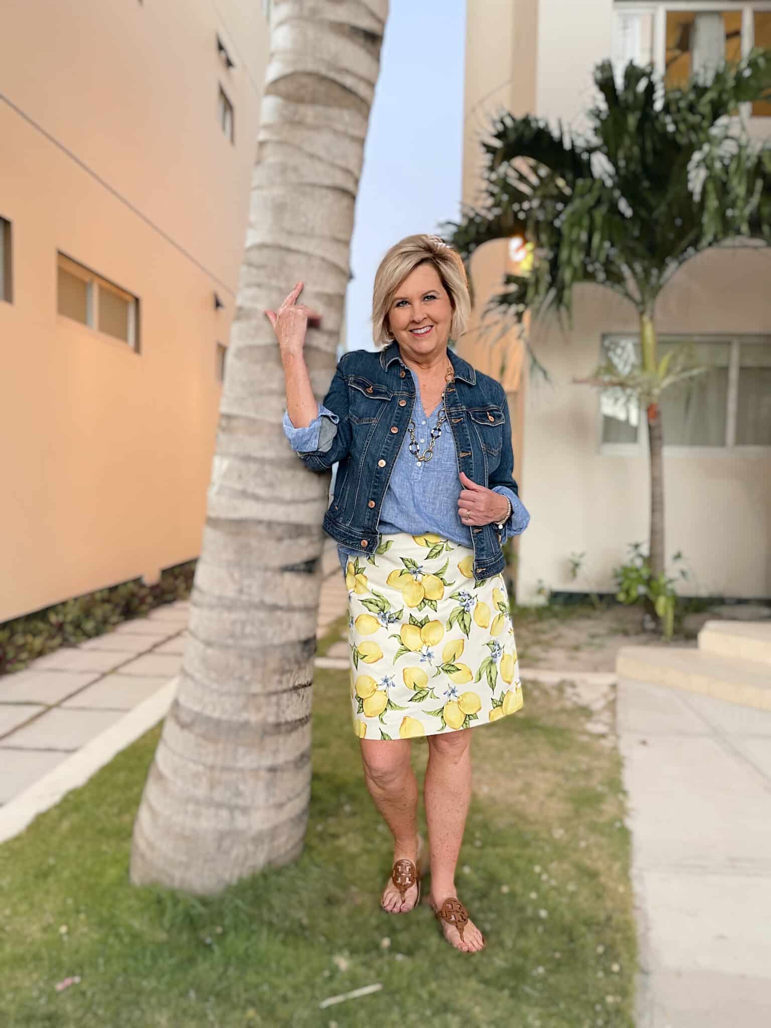 Over 40 Fashion Blogger, Tania Stephens is wearing a lemon print skirt, a chambray tunic, and a denim jacket 2