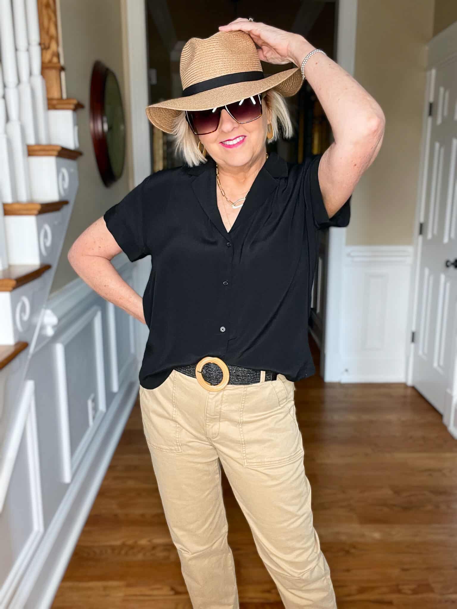 Over 40 Fashion Blogger, Tania Stephens is wearing a black short sleeve shirt with tan pants and a straw fedora2