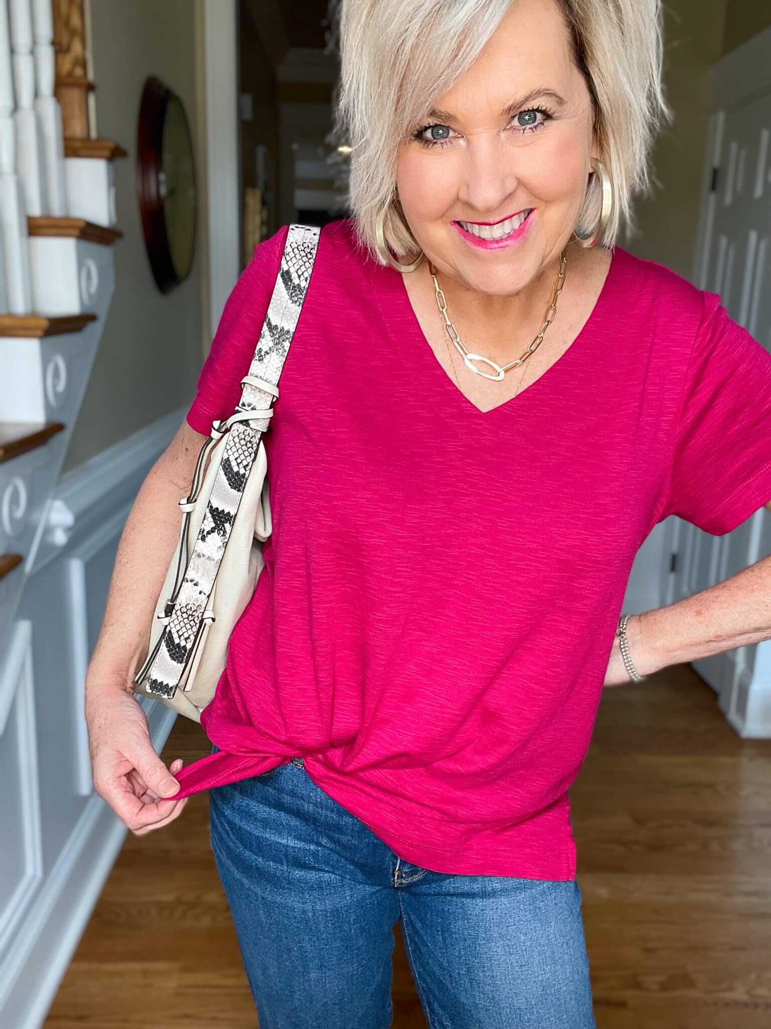 Over 40 Fashion Blogger, Tania Stephens is wearing a bright pink tee with cuffed jeans and loafers10