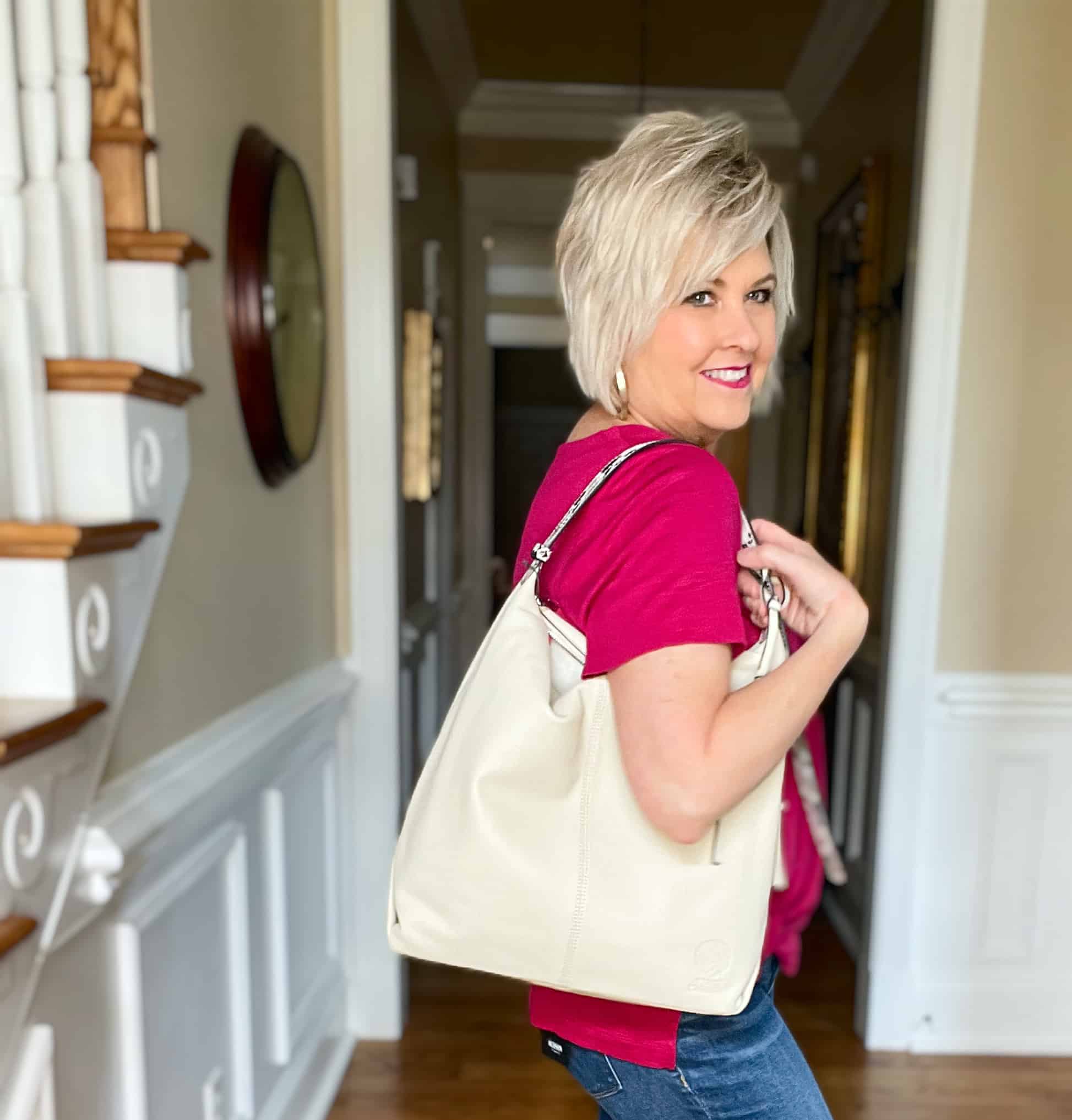 Over 40 Fashion Blogger, Tania Stephens is wearing a bright pink tee with cuffed jeans and loafers19