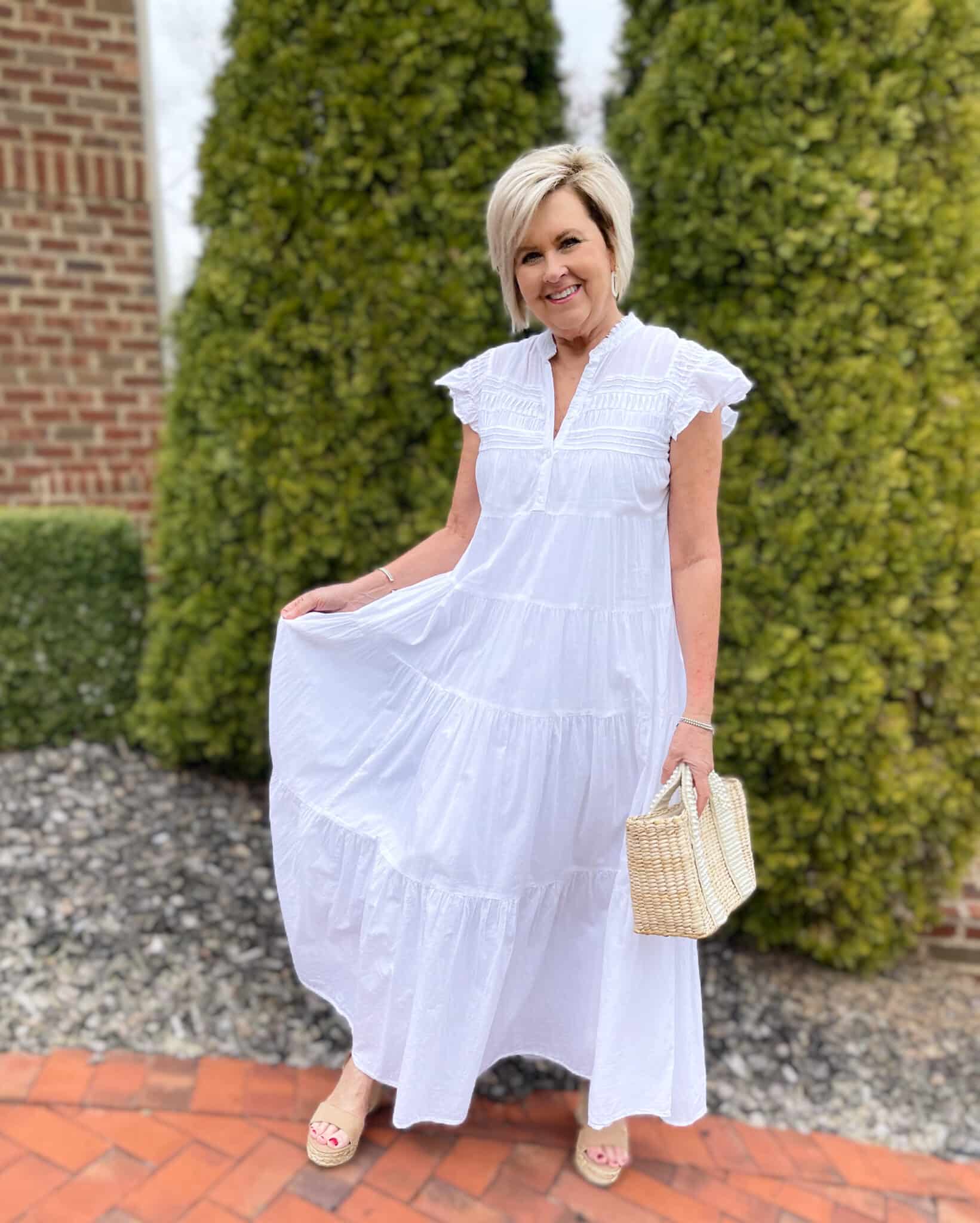 Over 40 Fashion Blogger, Tania Stephens is keeping wearing a white tiered maxi dress with a straw bag 18