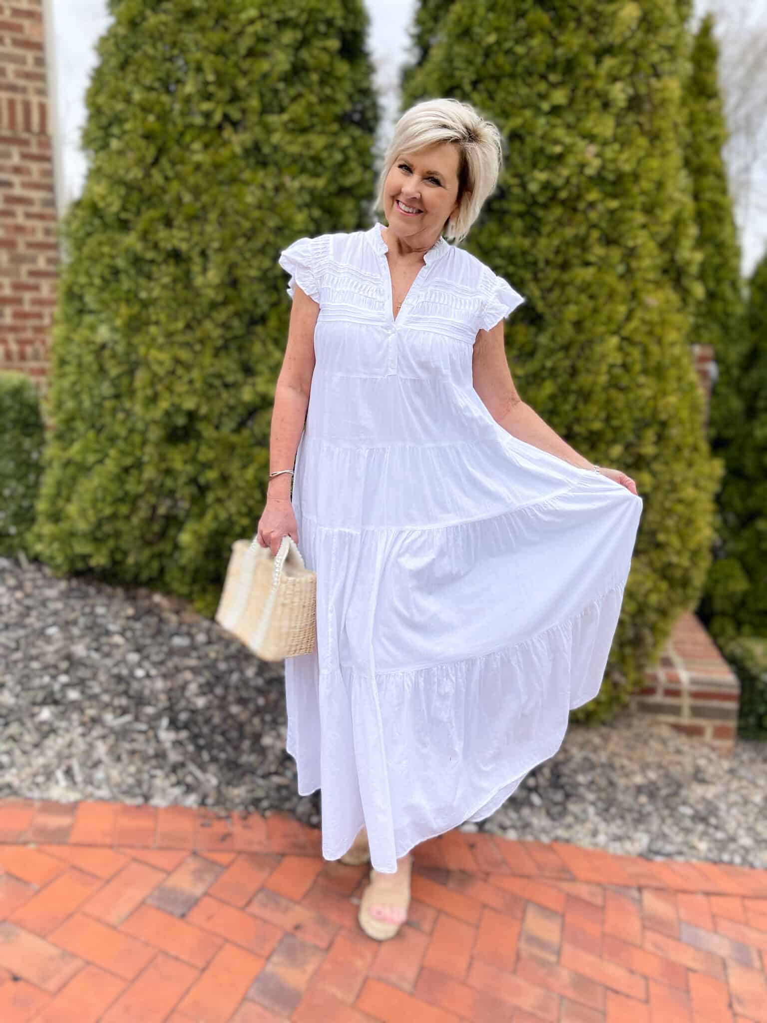 Over 40 Fashion Blogger, Tania Stephens is keeping wearing a white tiered maxi dress with a straw bag 4