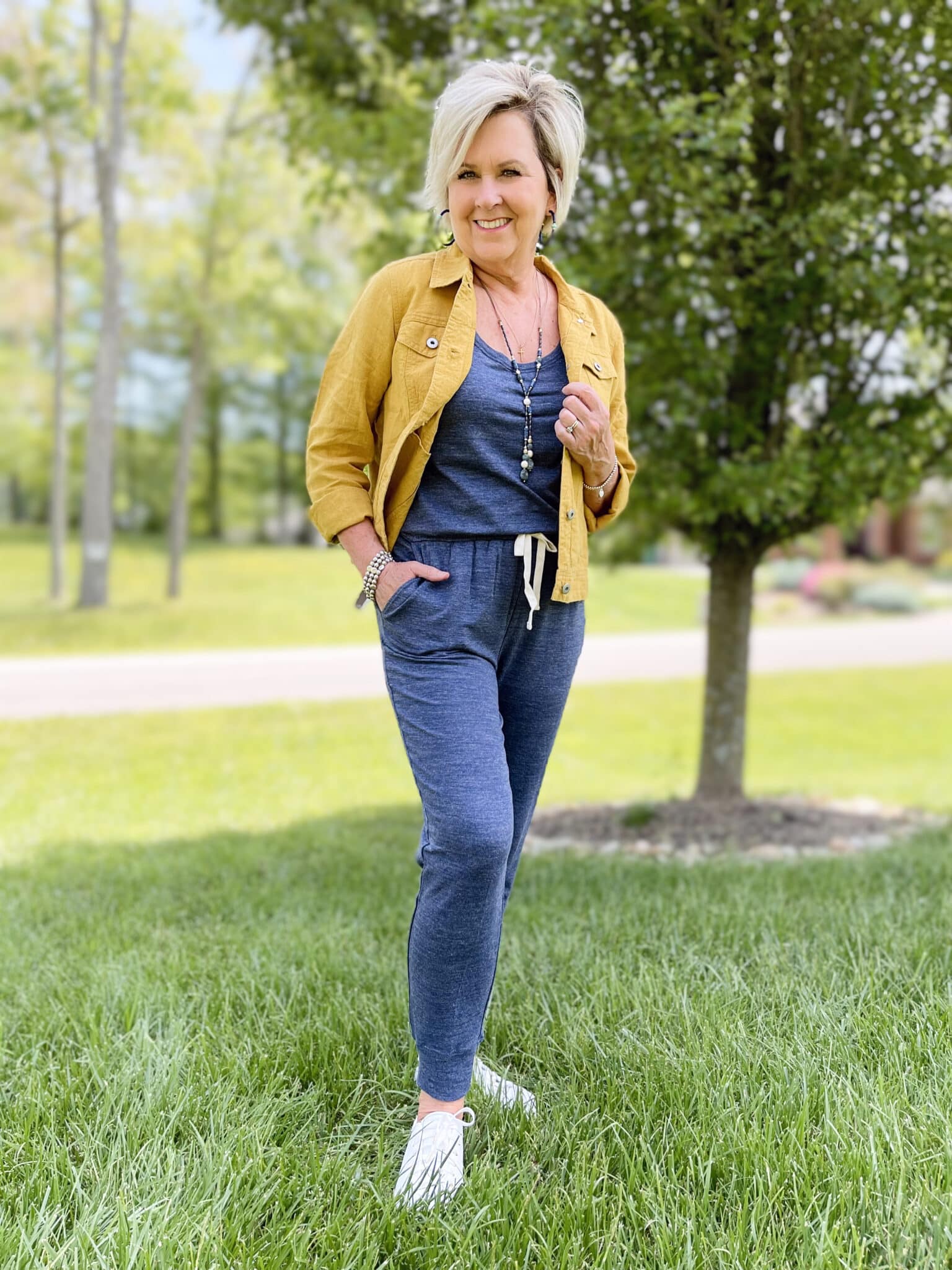 Over 40 Fashion Blogger, Tania Stephens is wearing a blue jumpsuit from Amazon and a mustard crop jacket from J.Jill1
