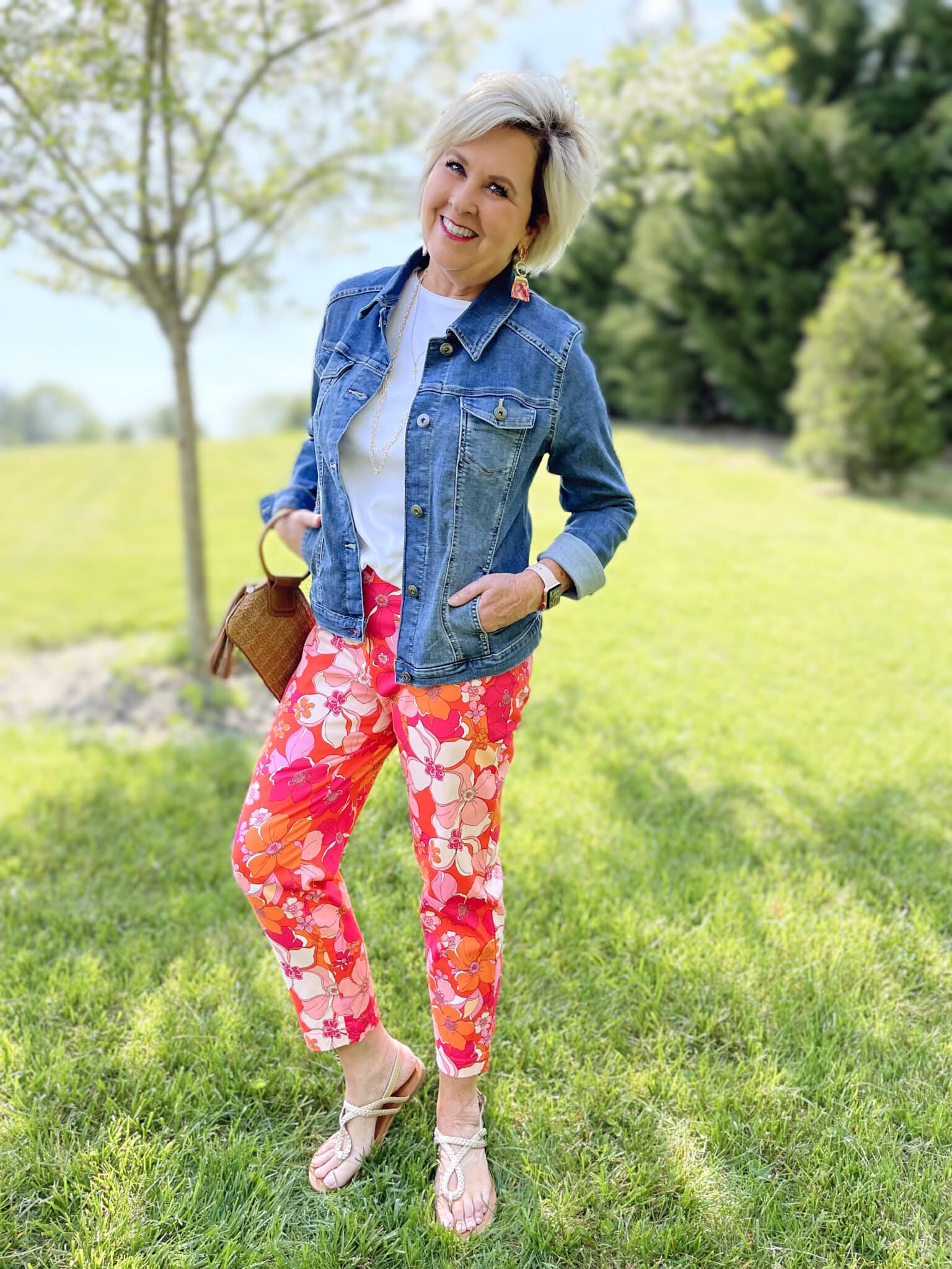 Over 40 Fashion Blogger, Tania Stephens is wearing floral pants, and white tee, and a denim jacket
