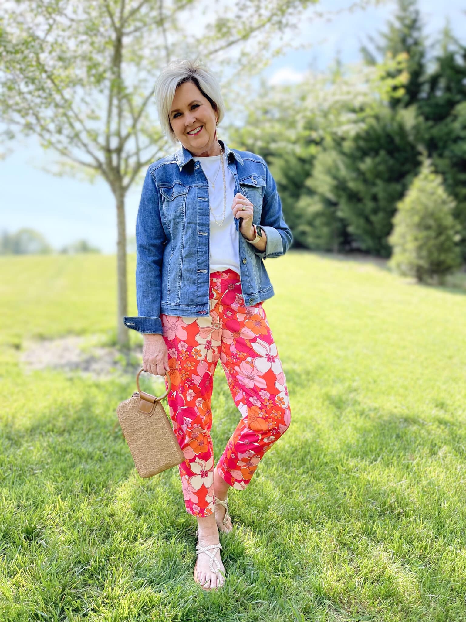 Over 40 Fashion Blogger, Tania Stephens is wearing floral pants, and white tee, and a denim jacket 14