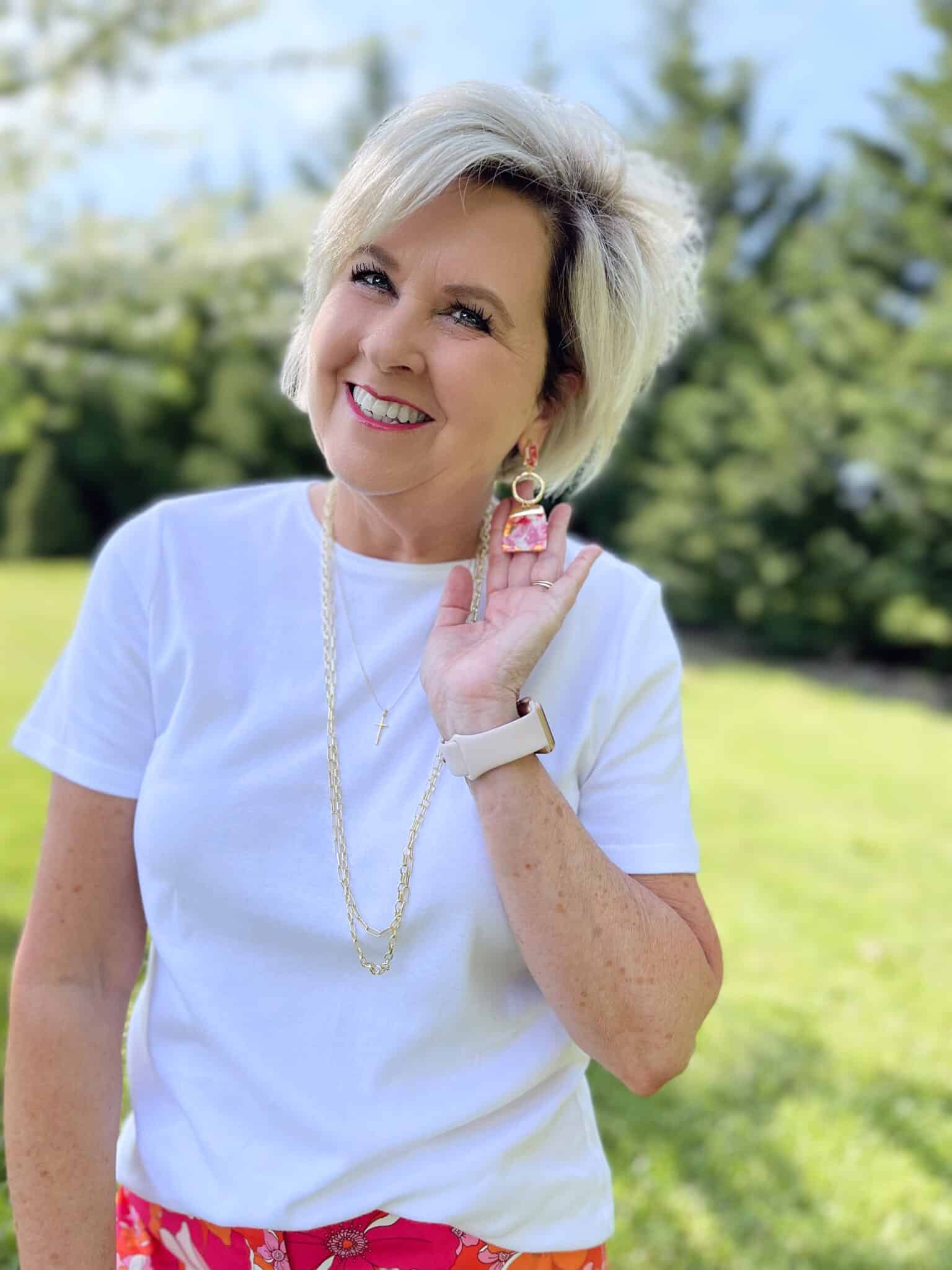 Over 40 Fashion Blogger, Tania Stephens is wearing floral pants, and white tee, and a denim jacket 5