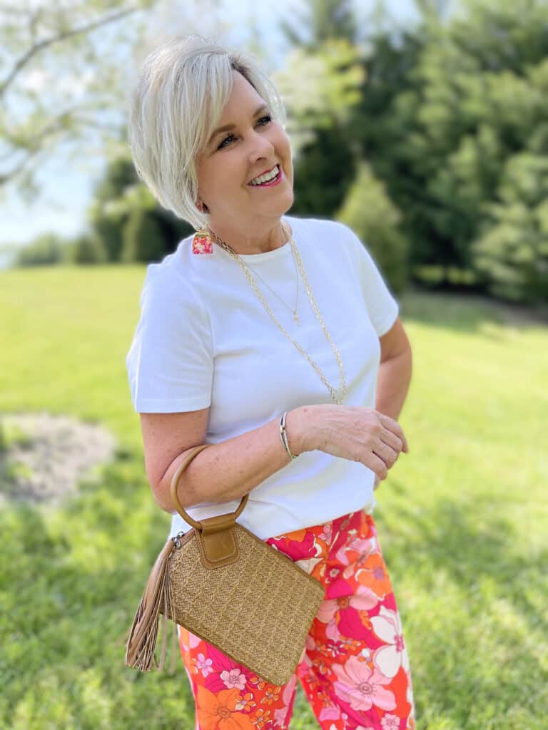 Over 40 Fashion Blogger, Tania Stephens is wearing floral pants, and white tee, and a denim jacket6