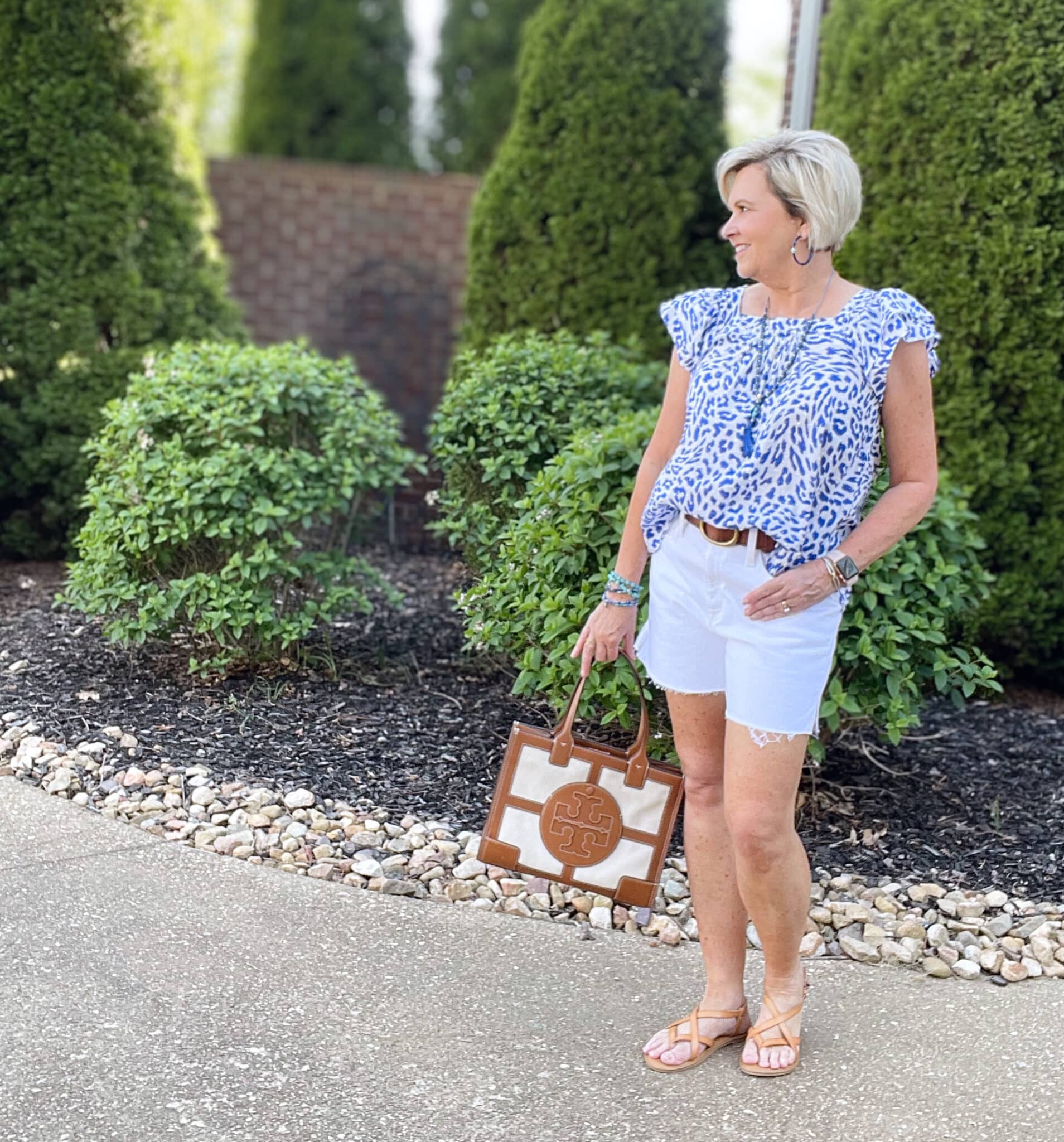 Over 40 Fashion Blogger, Tania Stephens is wearing a flutter sleeve top with white shorts and blue jewelry34