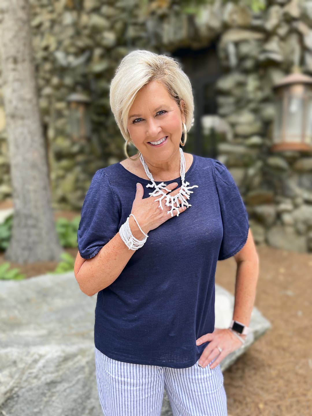 Over 40 Fashion Blogger, Tania Stephens is wearing a navy statement sleeve top with striped crop pants8