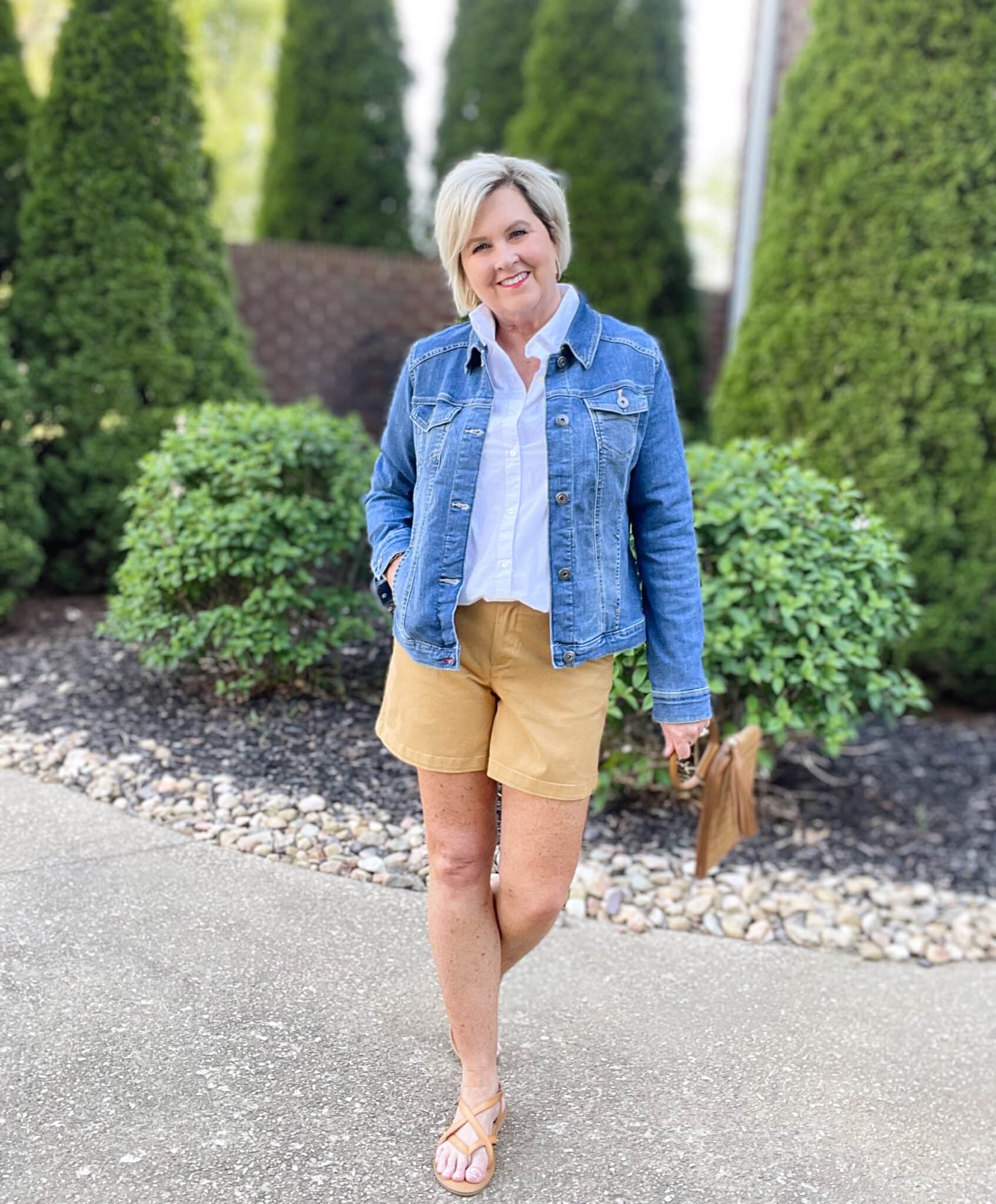 Over 40 Fashion Blogger, Tania Stephens is wearing tan shorts, a white shirt, and a denim jacket25