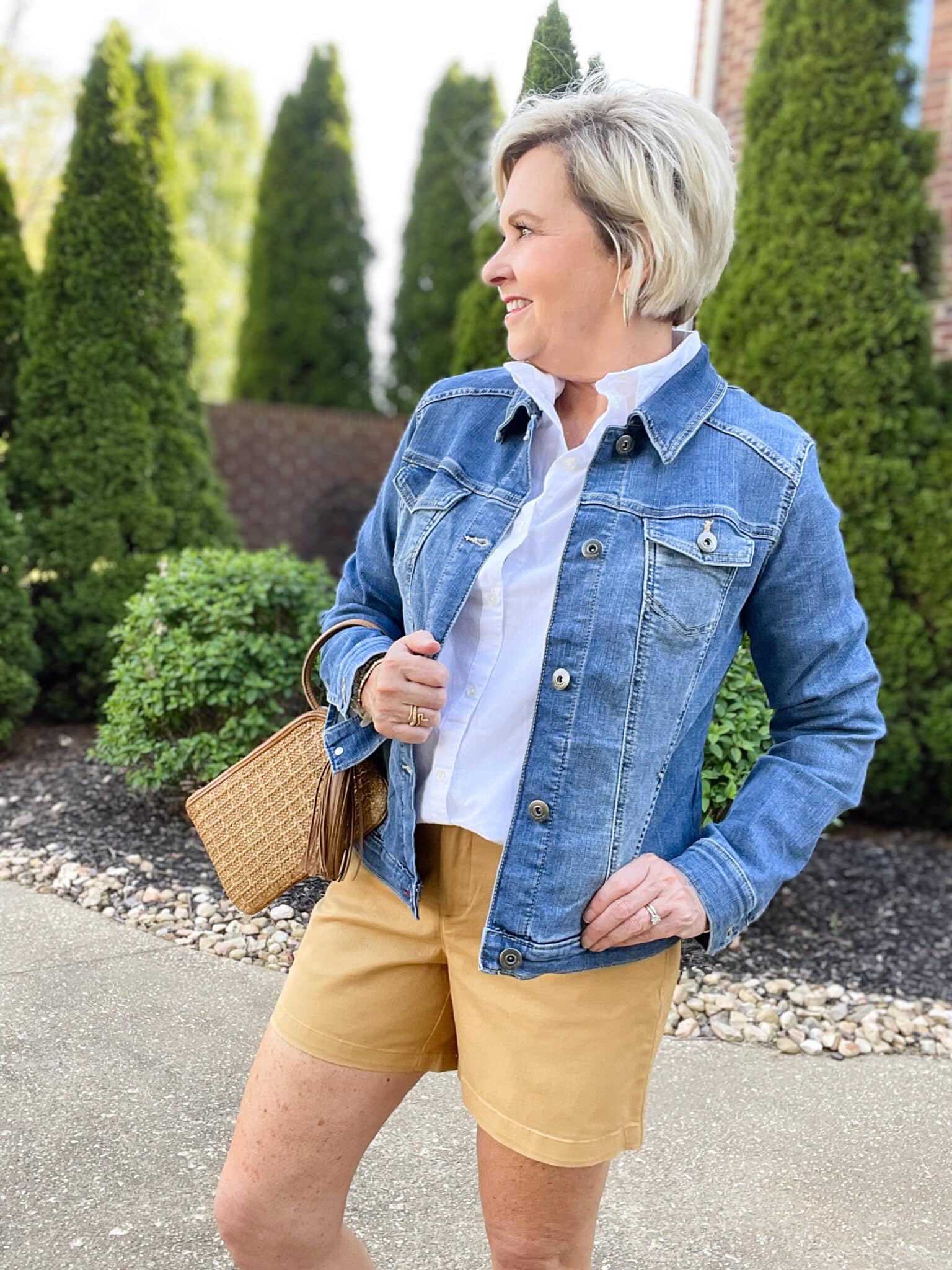 Over 40 Fashion Blogger, Tania Stephens is wearing tan shorts, a white shirt, and a denim jacket27