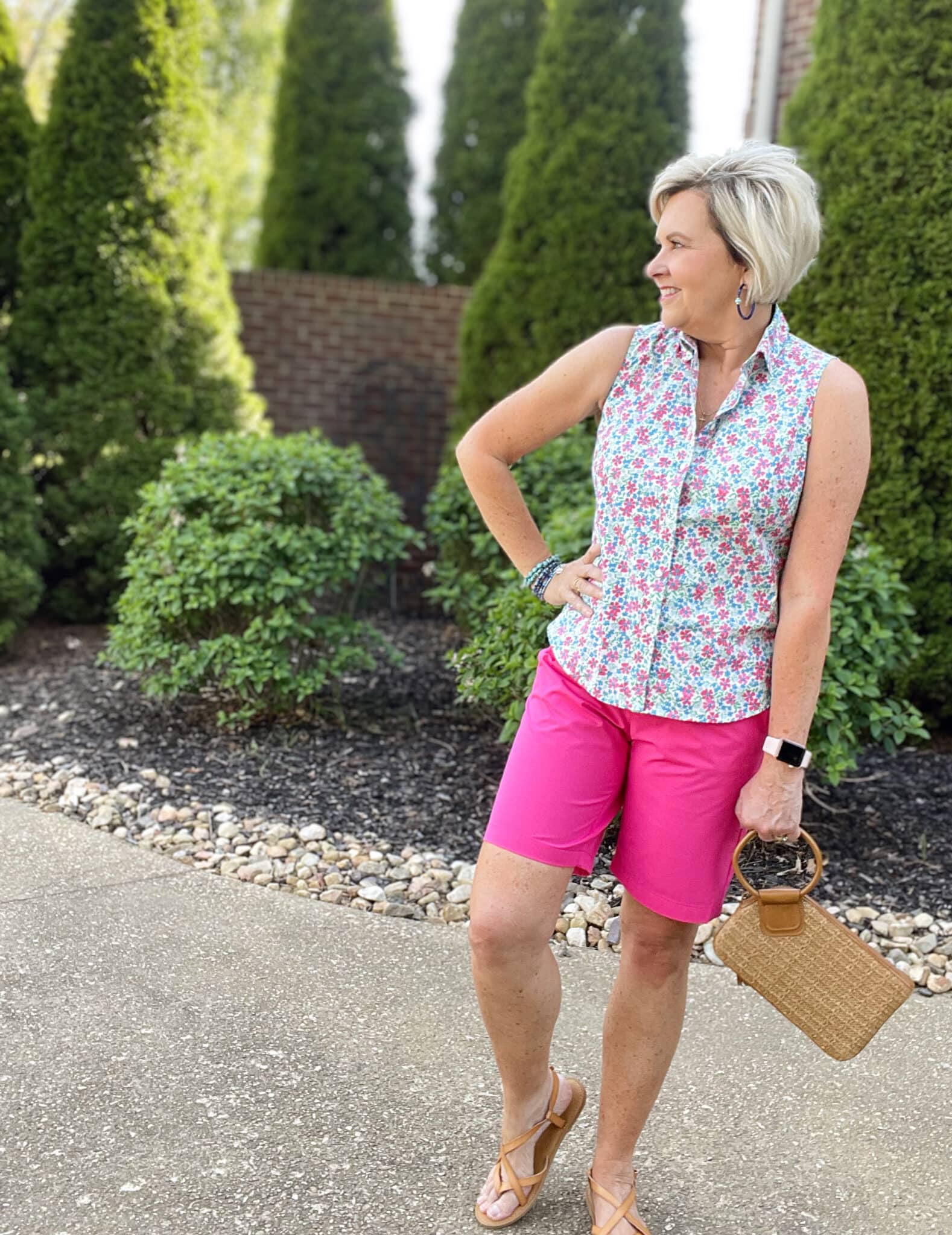 Over 40 Fashion Blogger, Tania Stephens is wearing pink shorts and a floral sleeveless top from J Crew Factory35