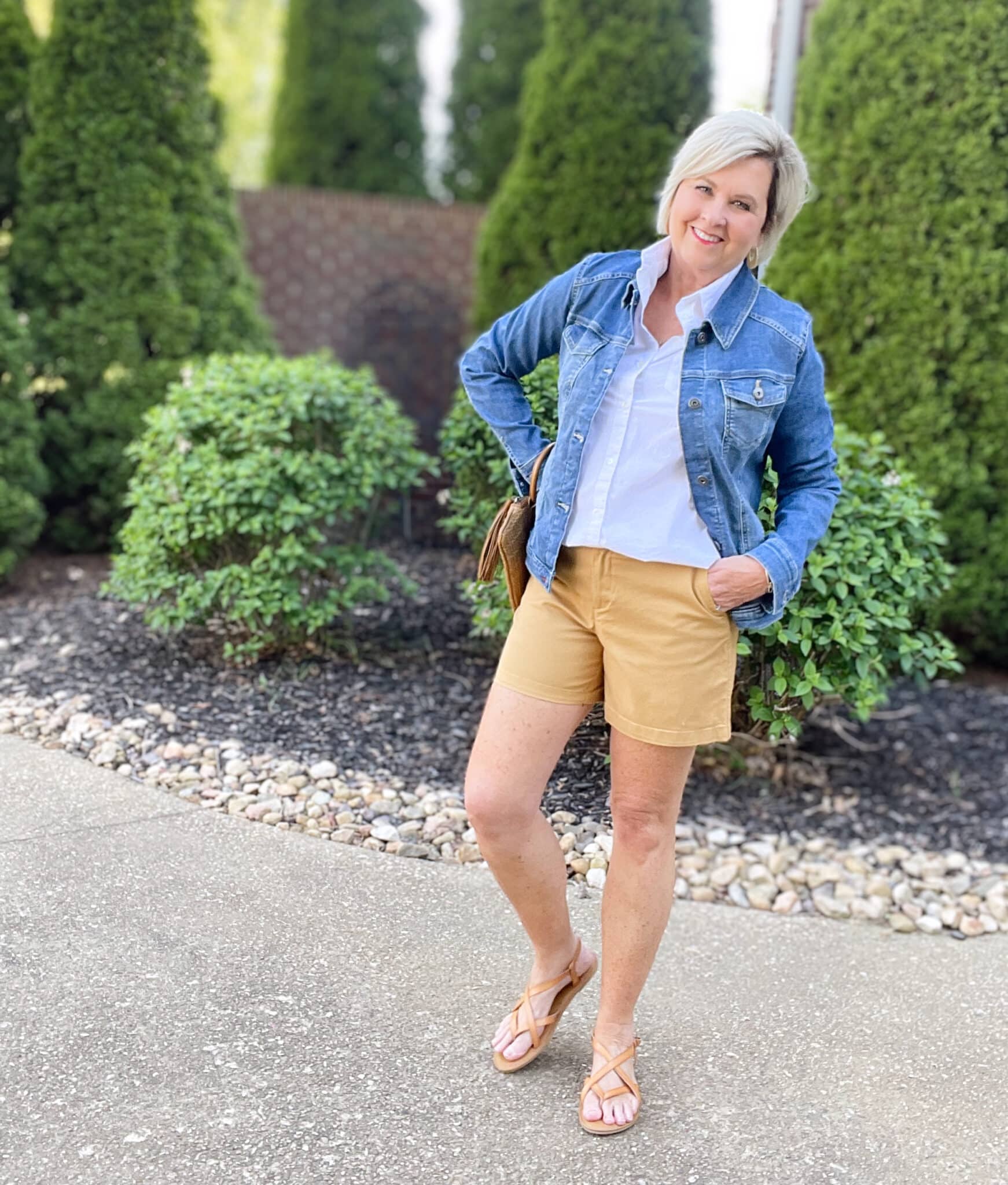 Over 40 Fashion Blogger, Tania Stephens is wearing tan shorts, a white shirt, and a denim jacket4