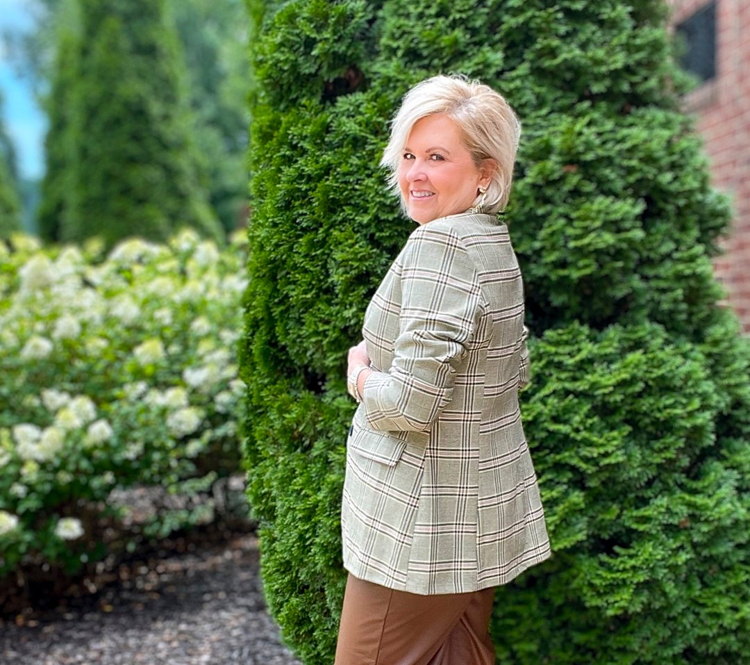 Over 40 Fashion Blogger, Tania Stephens is styling brown faux leather wide leg pant with a cream sweater and a plaid blazer7