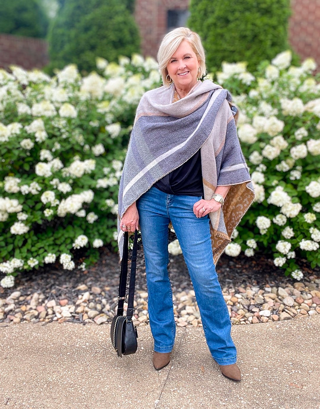 Over 40 Fashion Blogger, Tania Stephens is wearing a blanket poncho with jeans from Walmart25