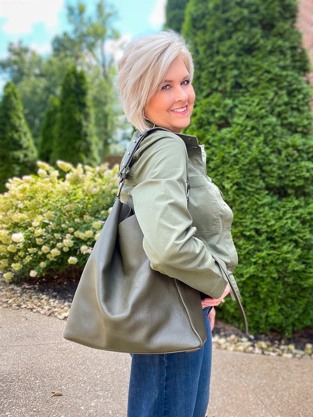 Over 40 Fashion Blogger, Tania Stephens is wearing an olive green jacket and sweater tank from Banana Republic5
